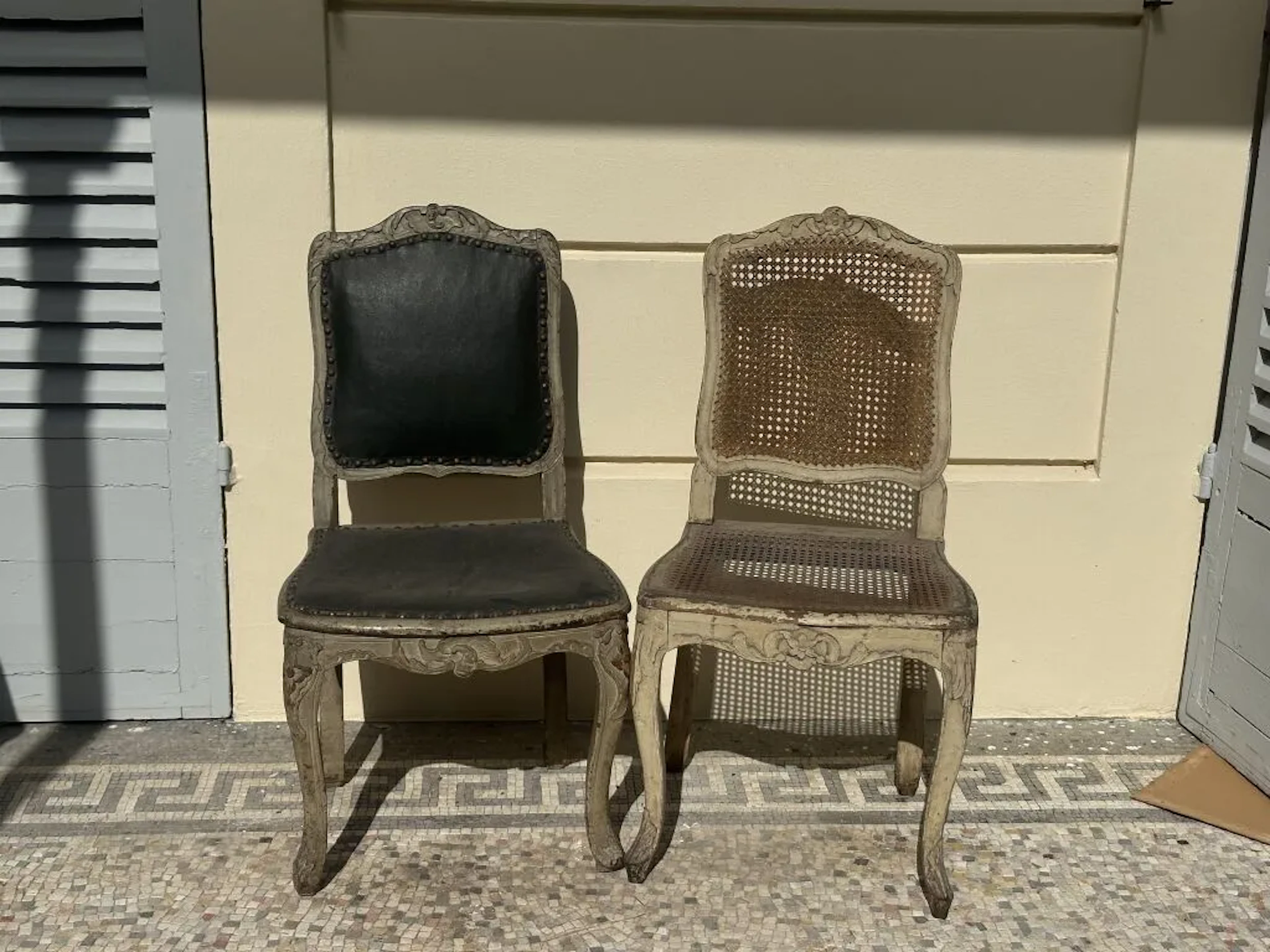 Pair of gray-refinished wooden chairs with carved foliage and floral