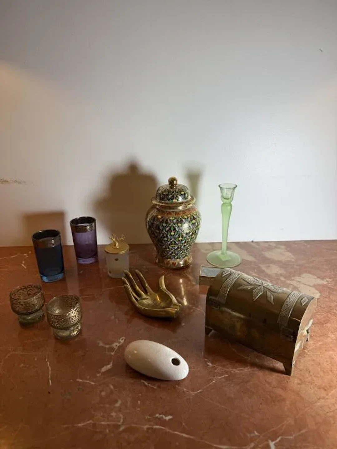 Vacation souvenirs: a bronze ashtray shaped like a hand, two liqueur
