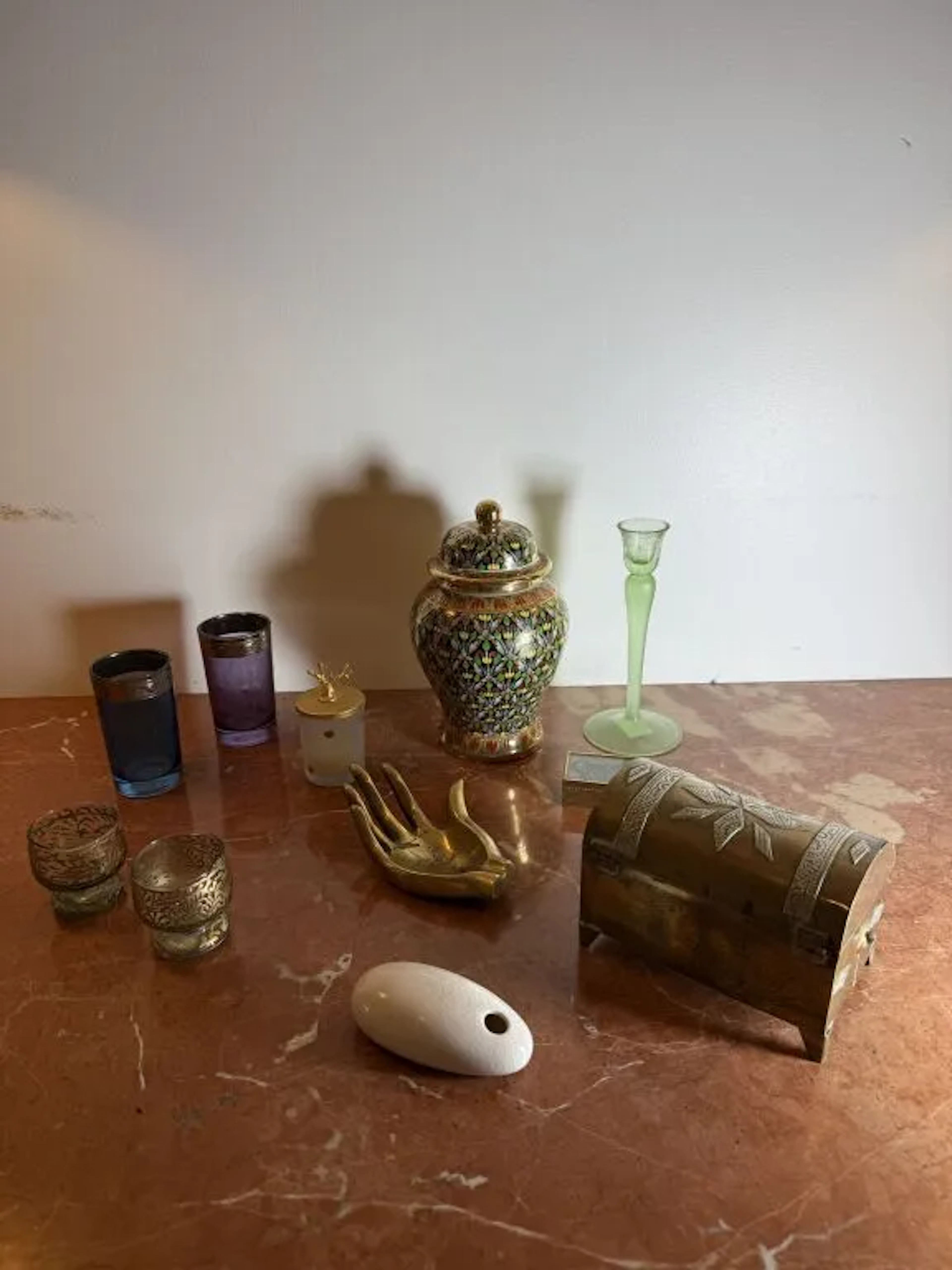 Vacation souvenirs: a bronze ashtray shaped like a hand, two liqueur