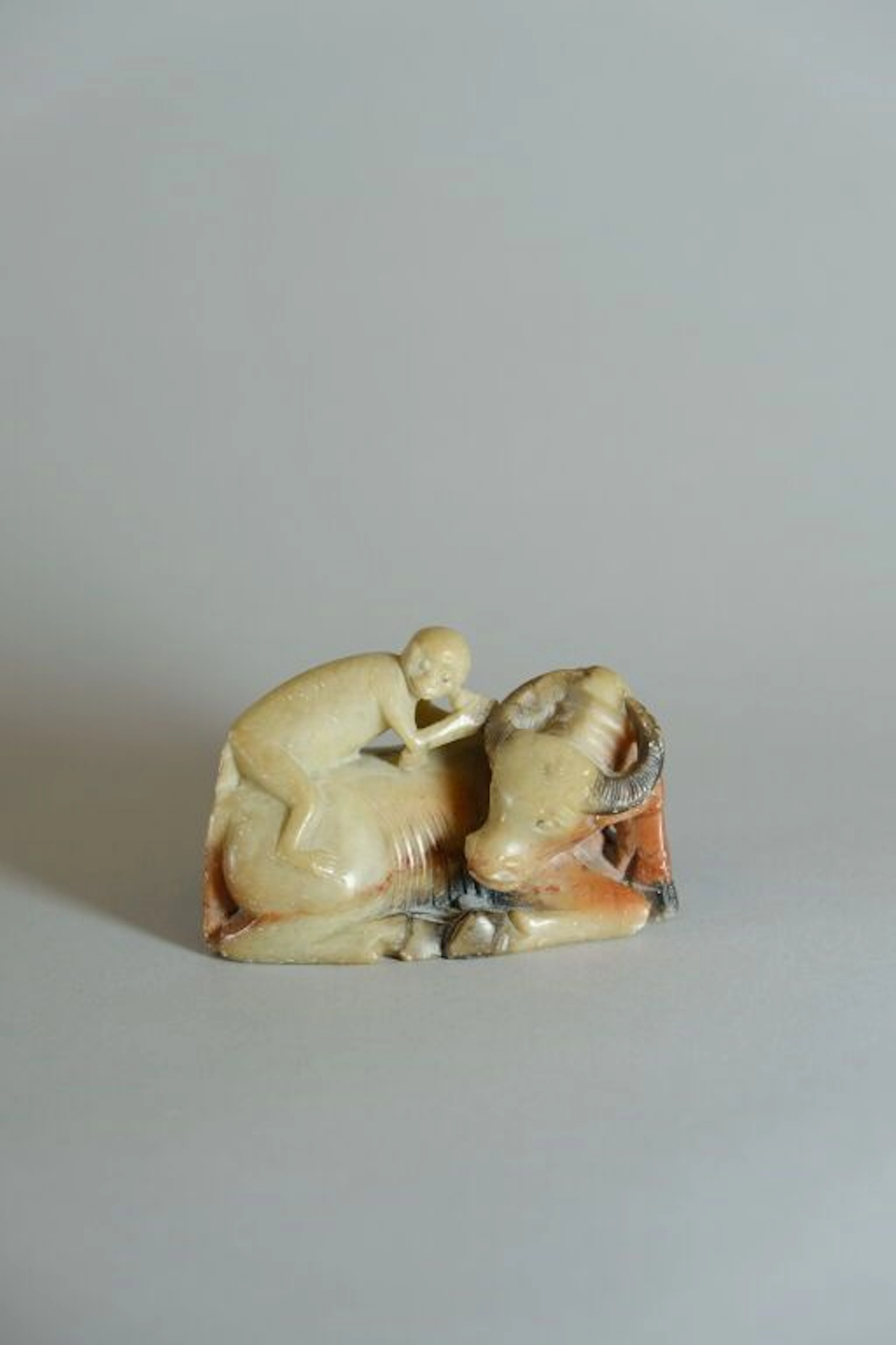 VIETNAM or SOUTHEAST ASIA, 20th century. Small monkey on a water buffalo.