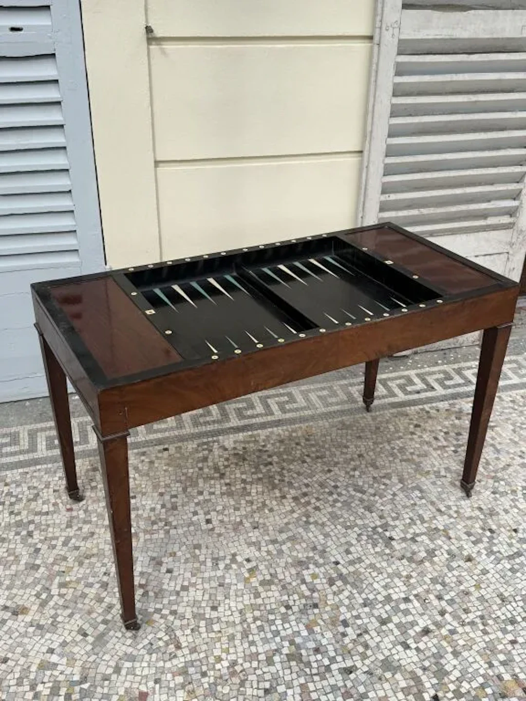 A game table known as a "tric-trac," made of mahogany and mahogany