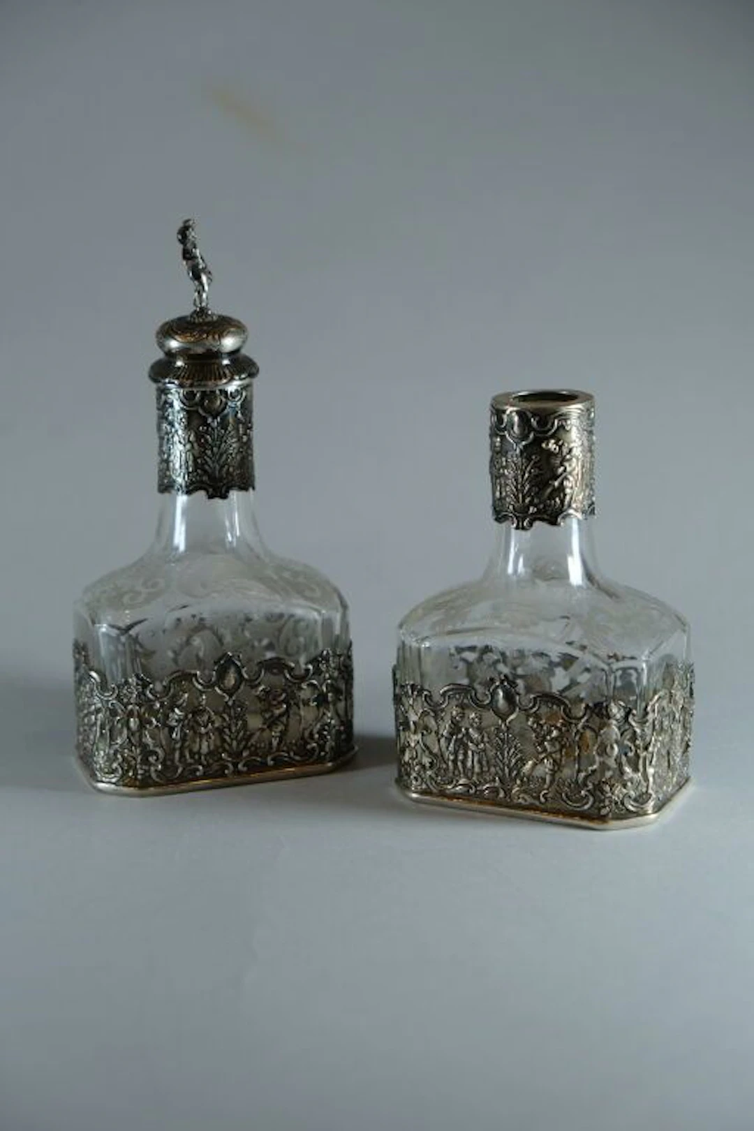 Pair of engraved crystal bottles, with 800/1000 silver mounts. Silver