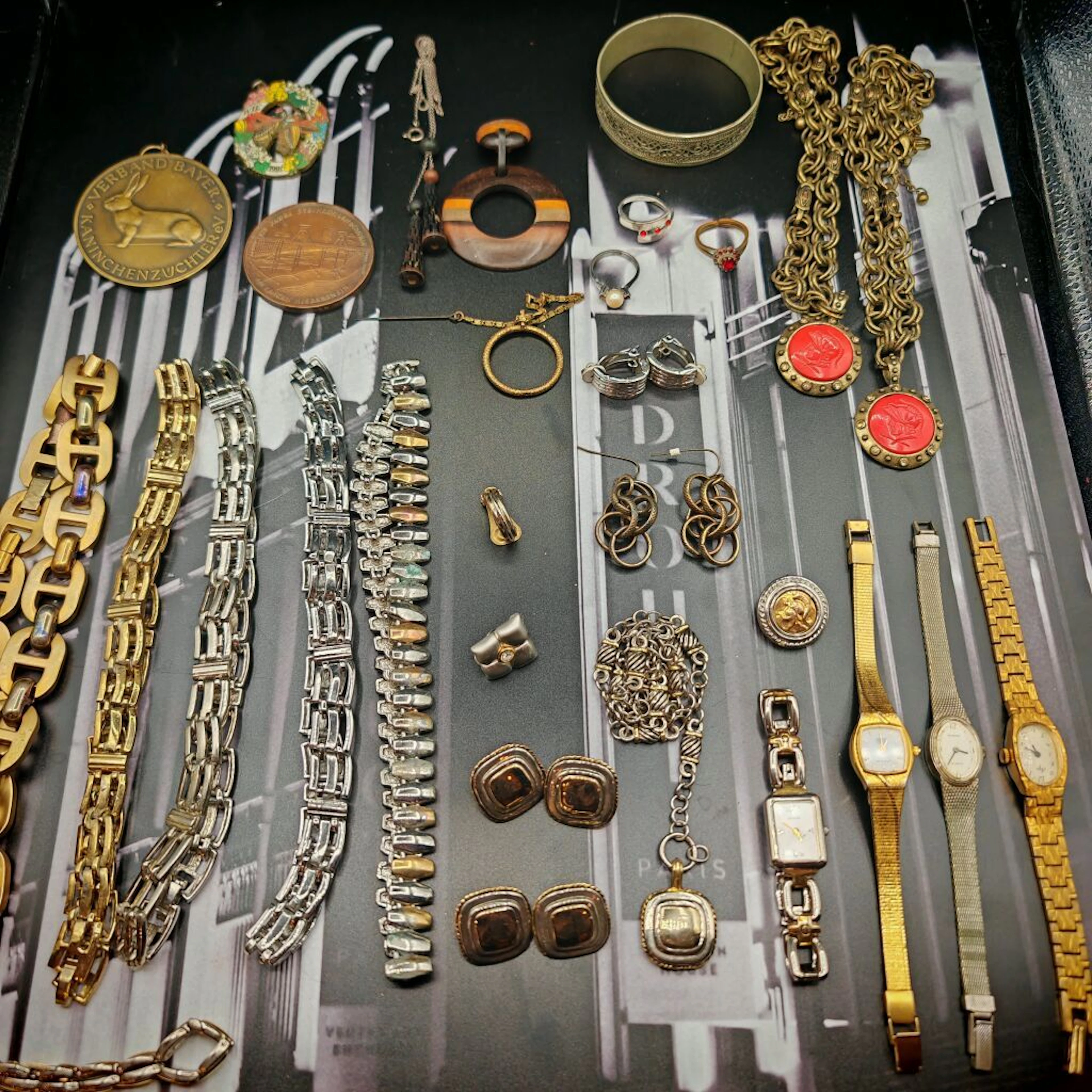 A collection of costume jewelry and watches made of metal, gold-plated
