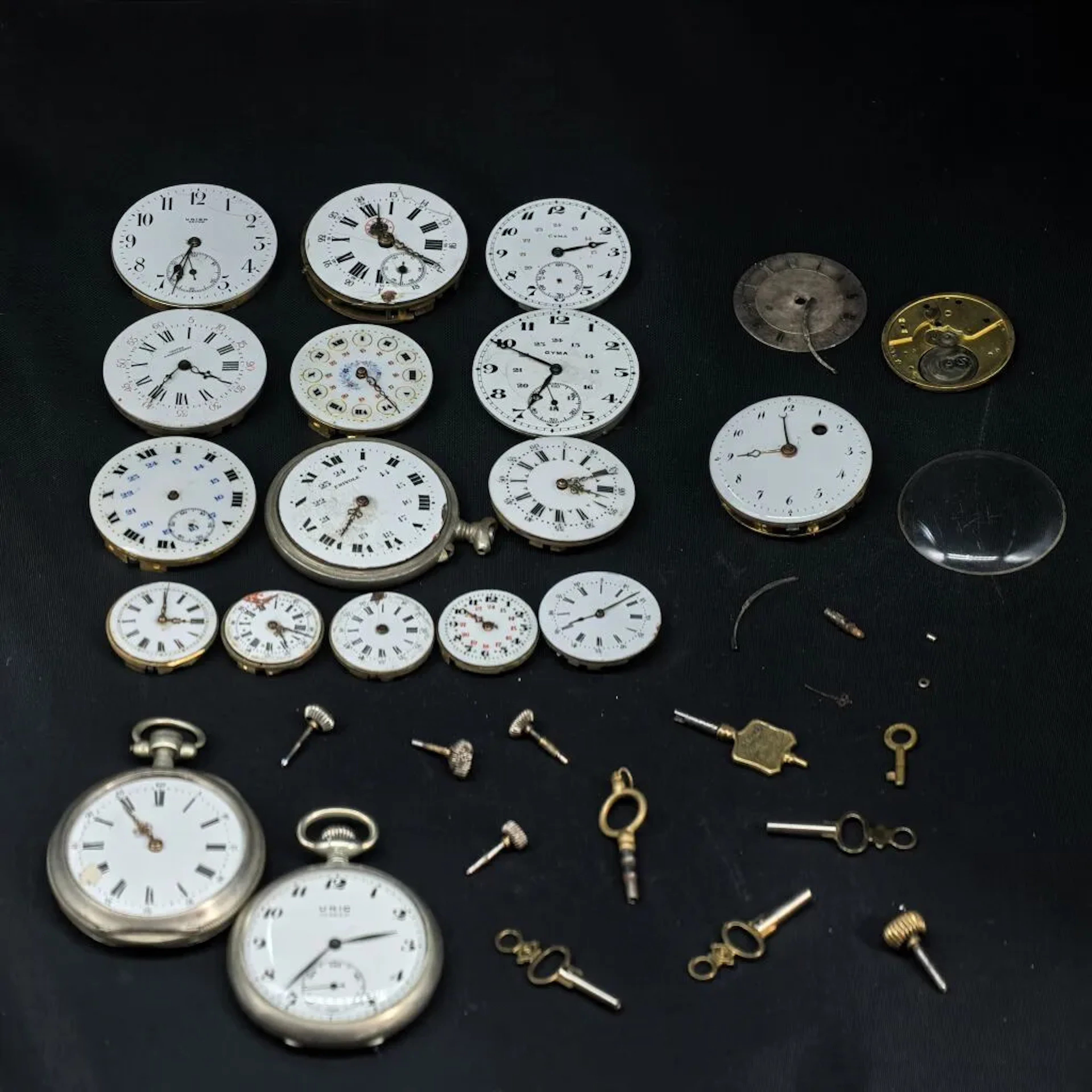 LOT: Base metal timepieces, watches and spare parts, movements, and