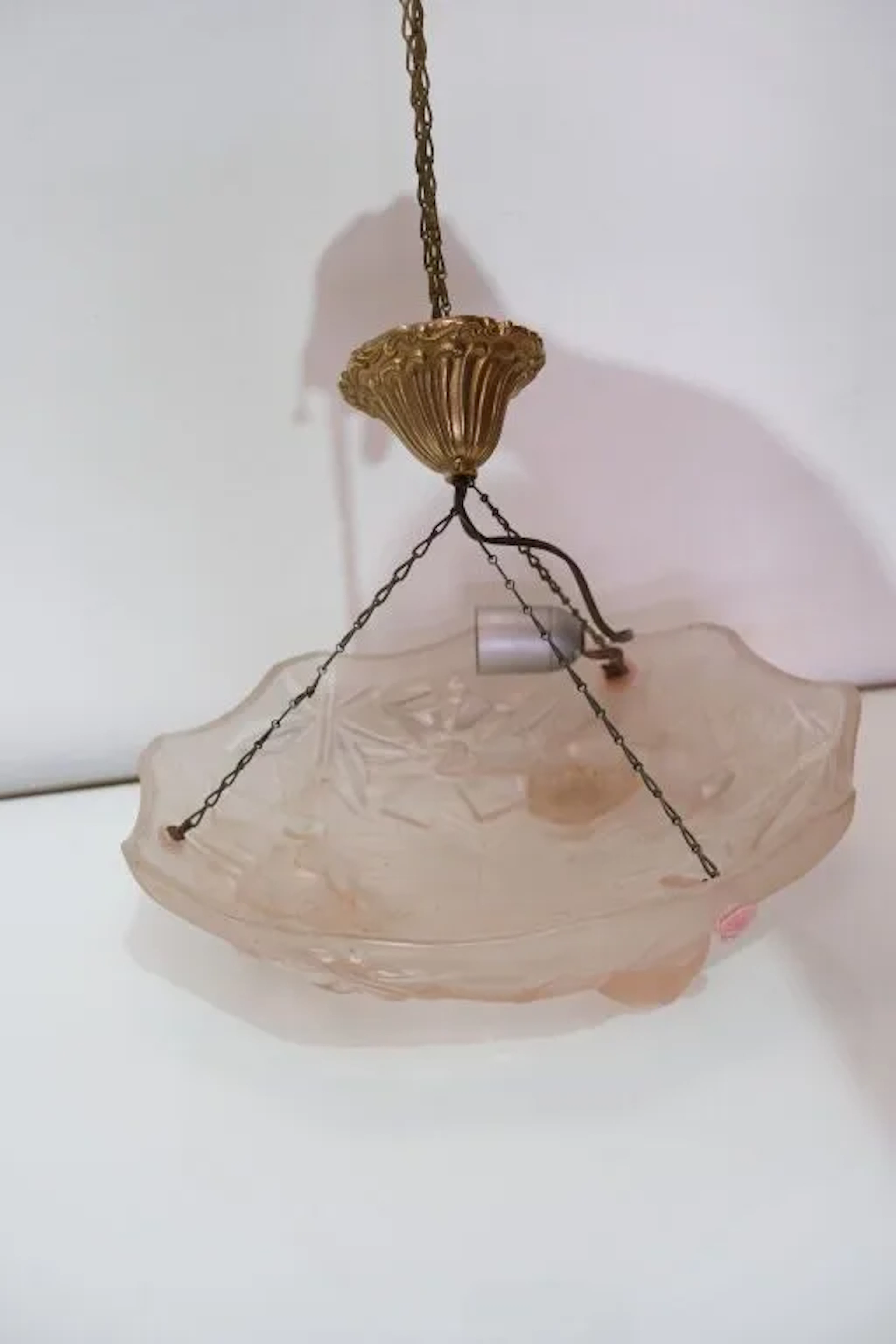 A pressed-molded glass pendant lamp, largely frosted, decorated with