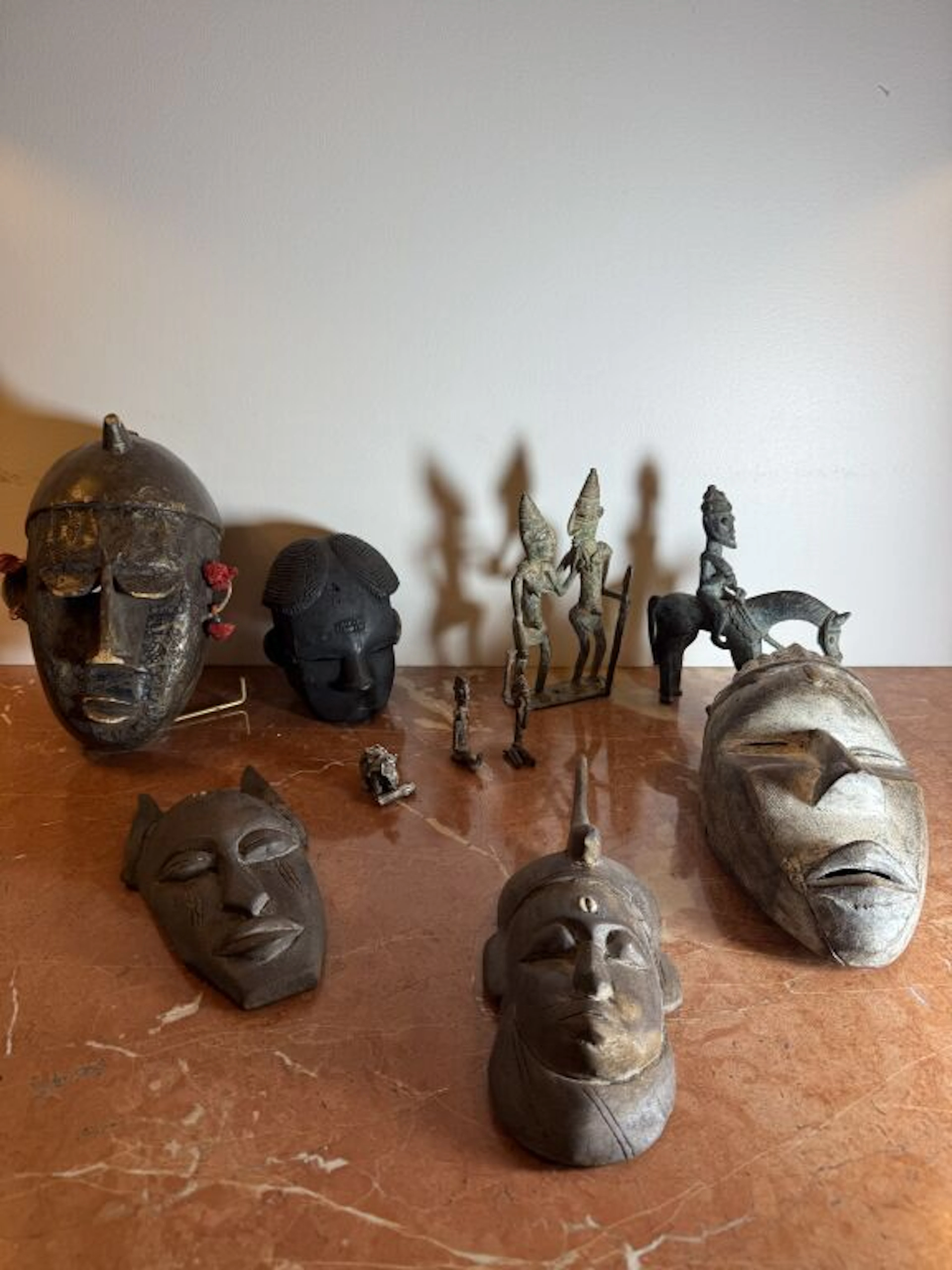 Central Africa. A set of five wooden masks, two adorned with a seashell