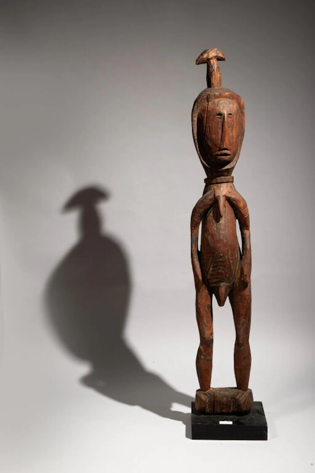 Statue depicting a standing man, carved from hardwood with an antique