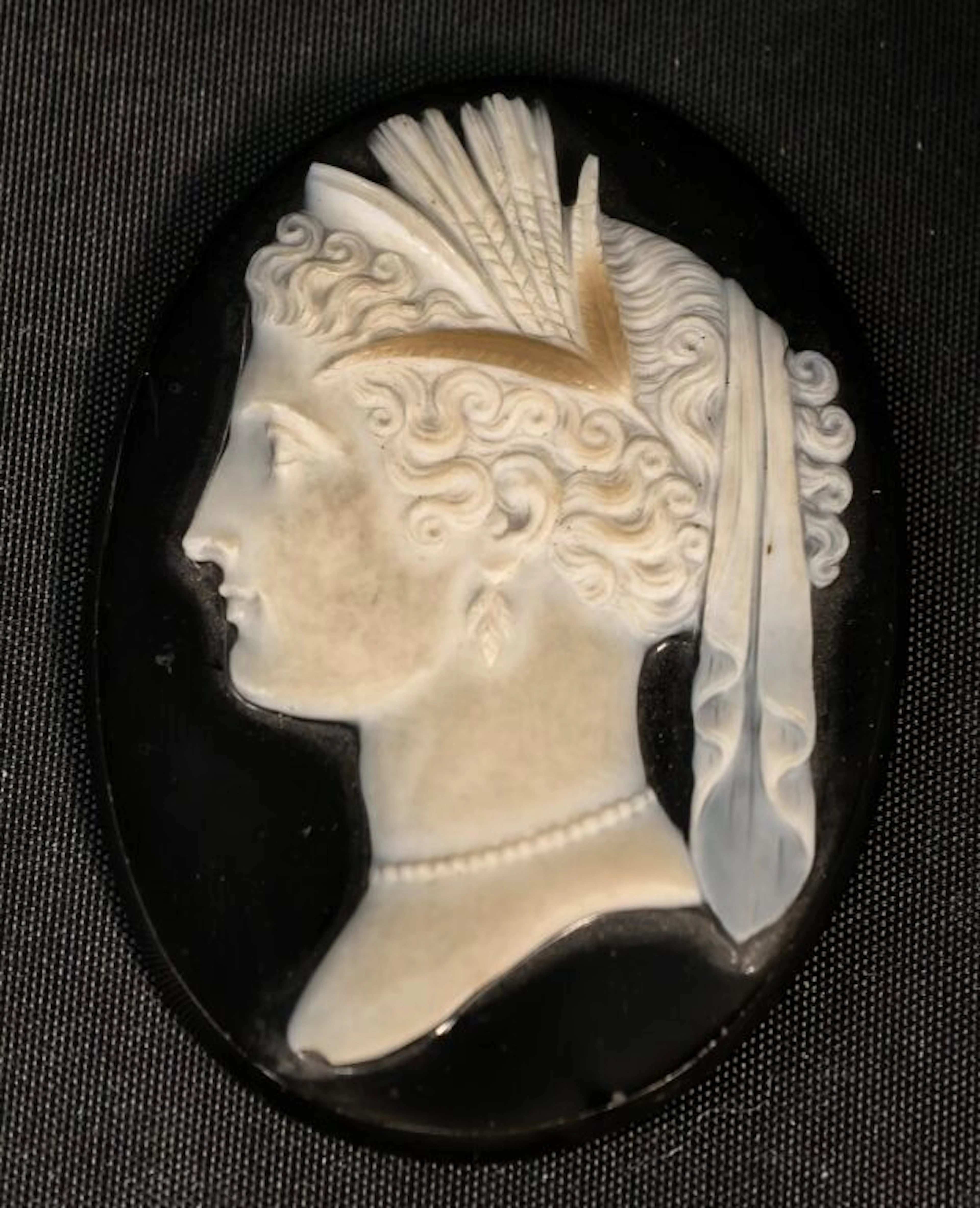 A cameo on multilayered onyx depicting the profile of a woman with