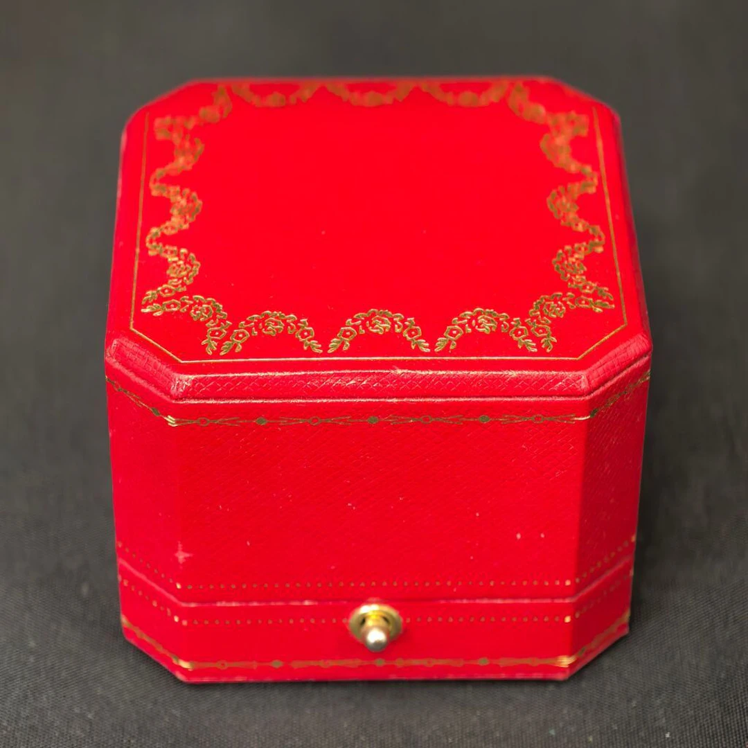 CARTIER, circa 1980–1990. A ring box with gold-tone decoration and