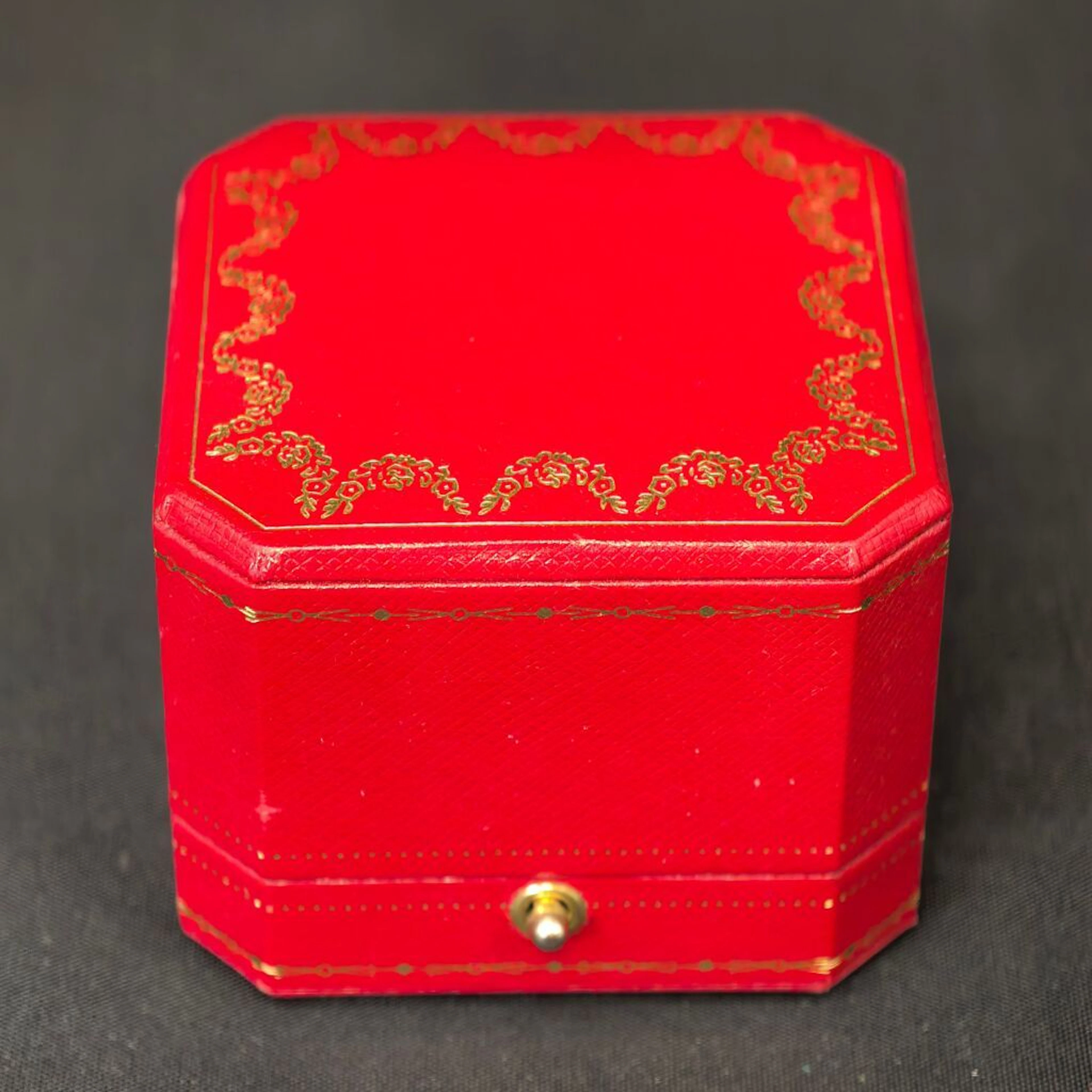 CARTIER, circa 1980–1990. A ring box with gold-tone decoration and