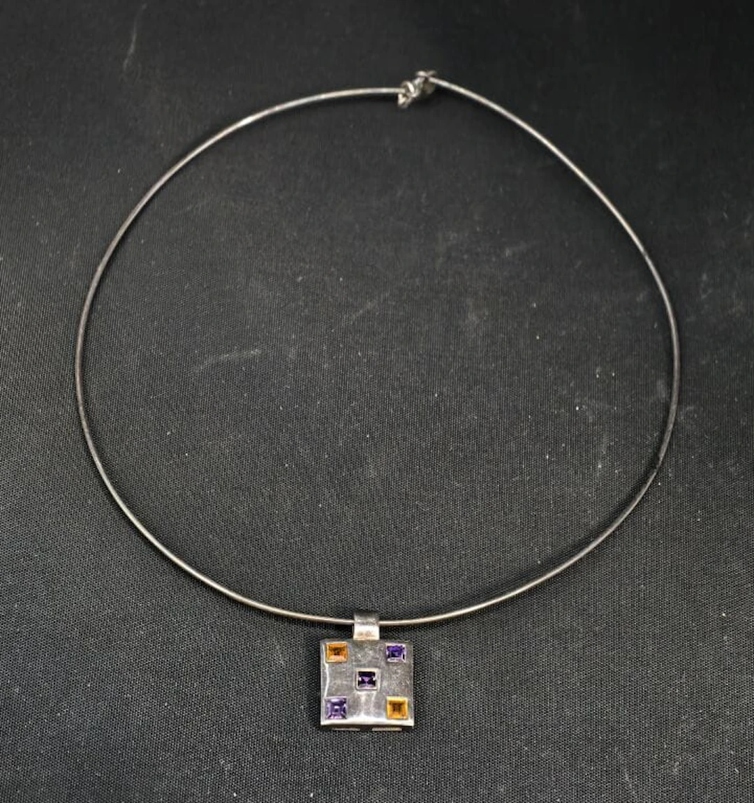 A 925‰ silver wire choker featuring a sliding square-shaped motif