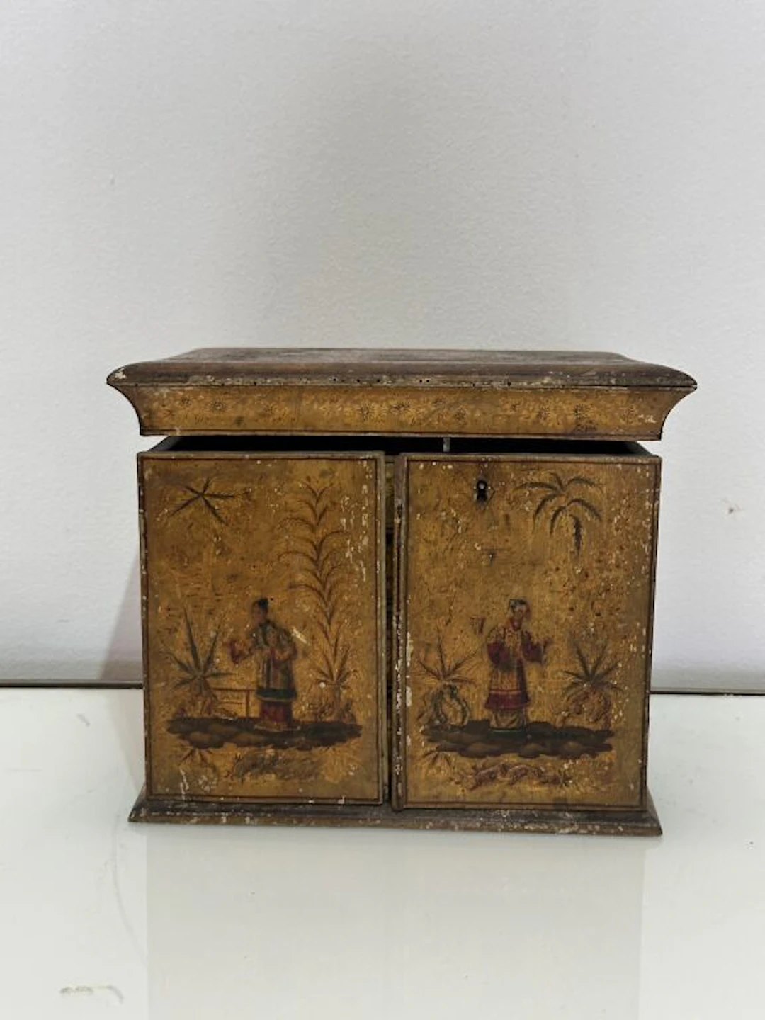 A lacquered wooden jewelry or sewing box with polychrome and gold