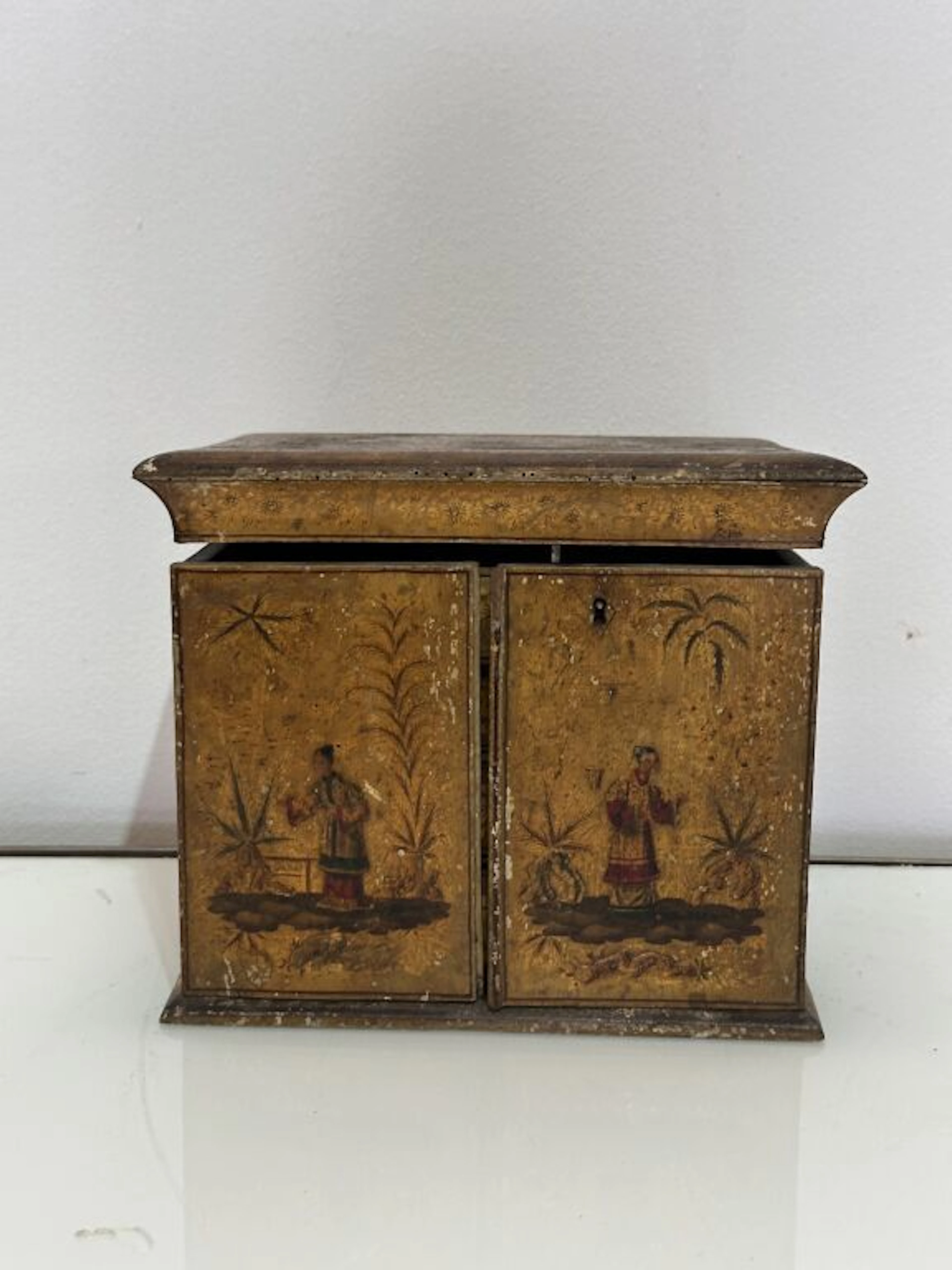 A lacquered wooden jewelry or sewing box with polychrome and gold