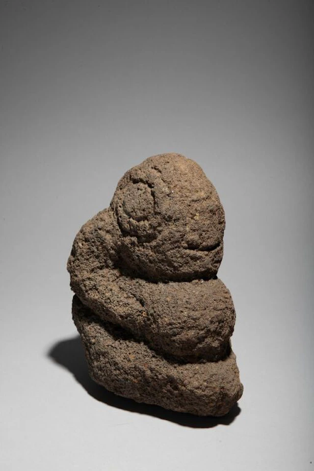 Basalt sculpture depicting a kneeling Tiki. Marquesas Islands. H: 16 cm.