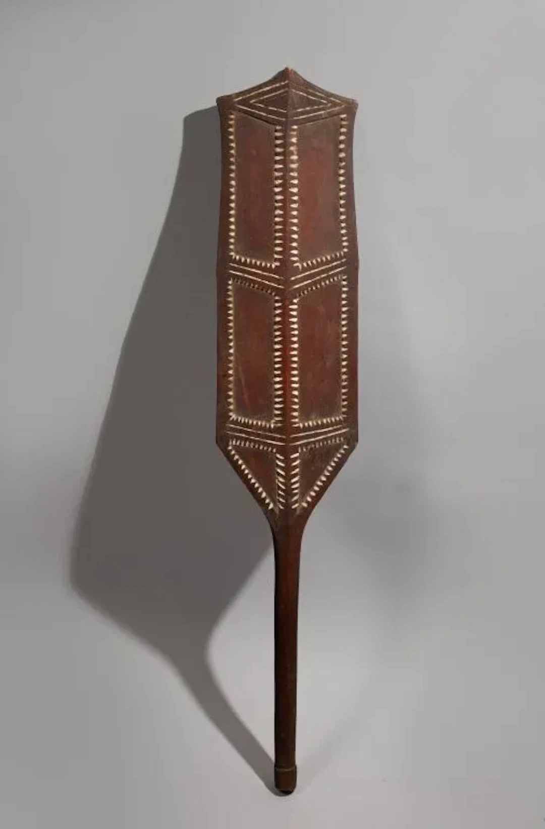 Dance palette with a geometric design in high relief, accented with