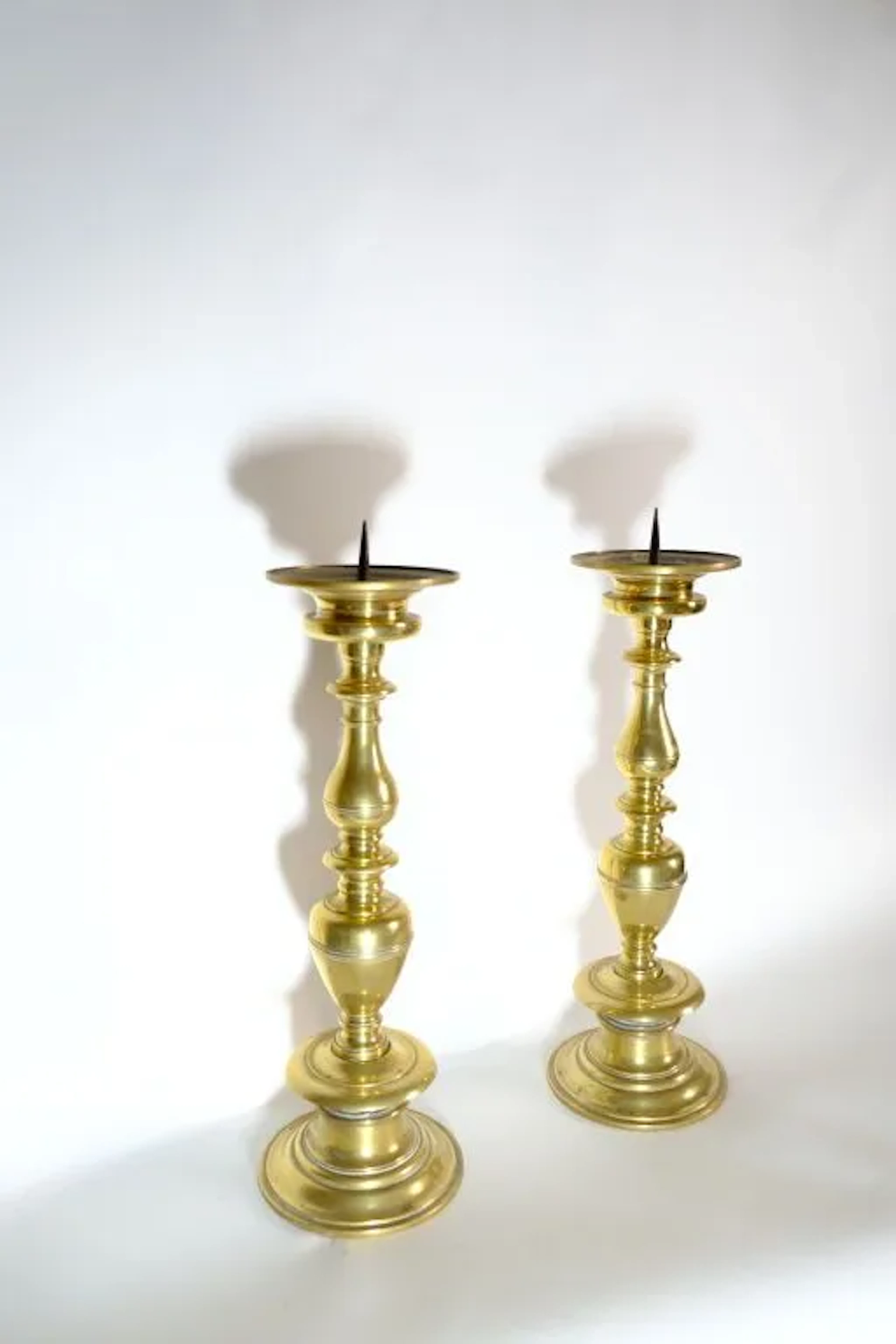 Pair of large, finely molded bronze candelabra; the shaft consists