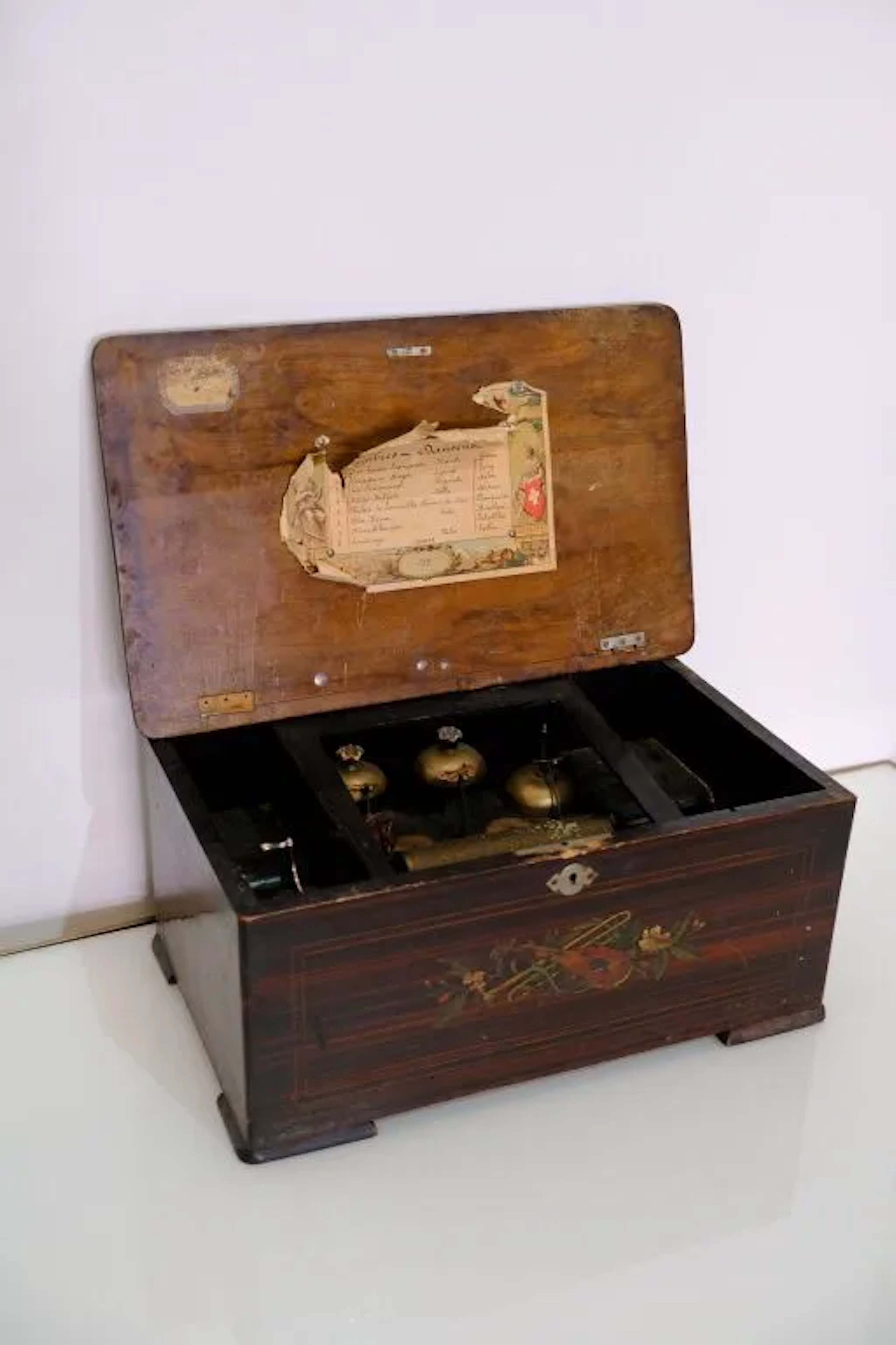 Music box featuring a cylinder with a textured protrusion and three