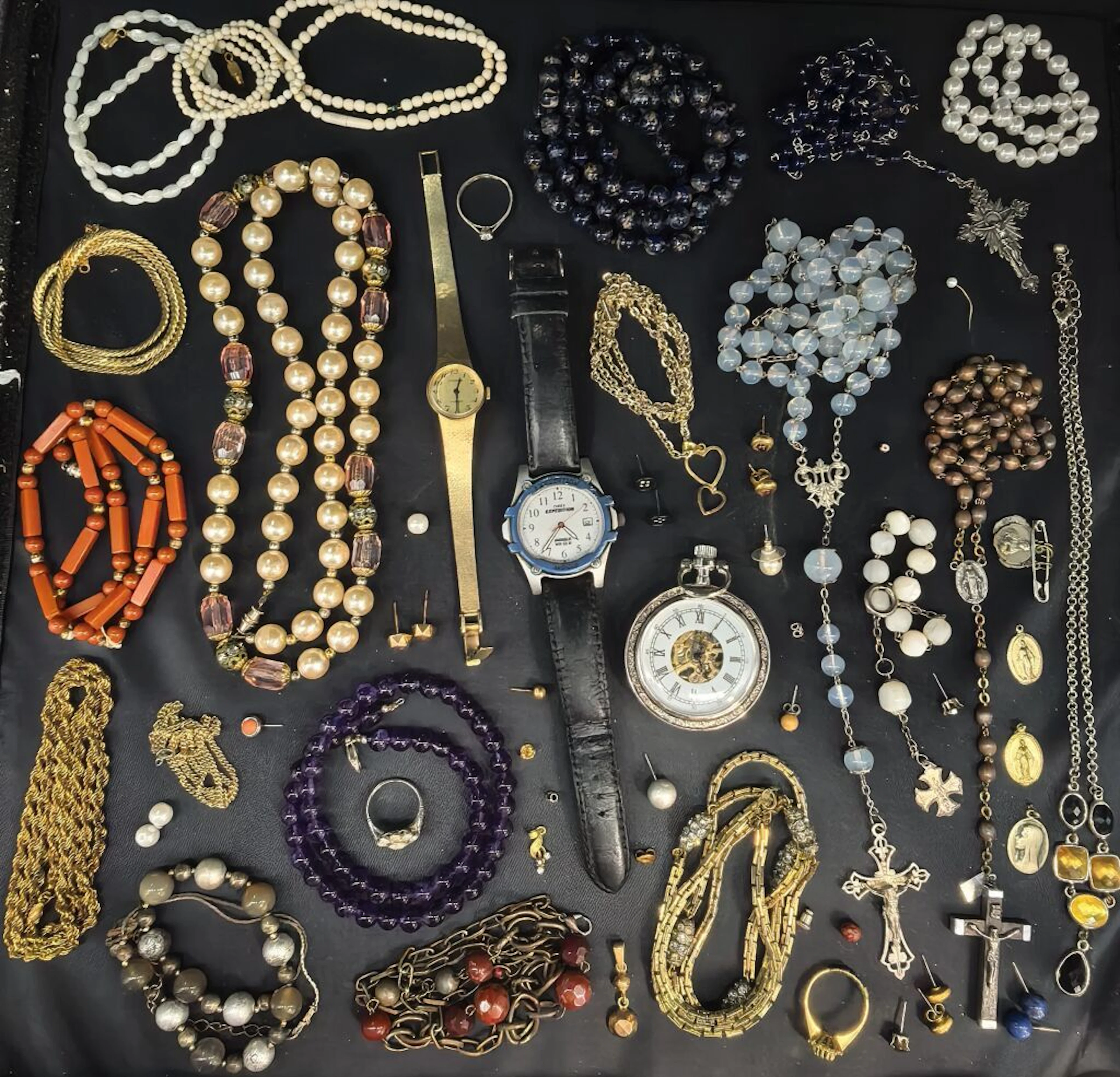 A collection of costume jewelry, including necklaces, a myriad of