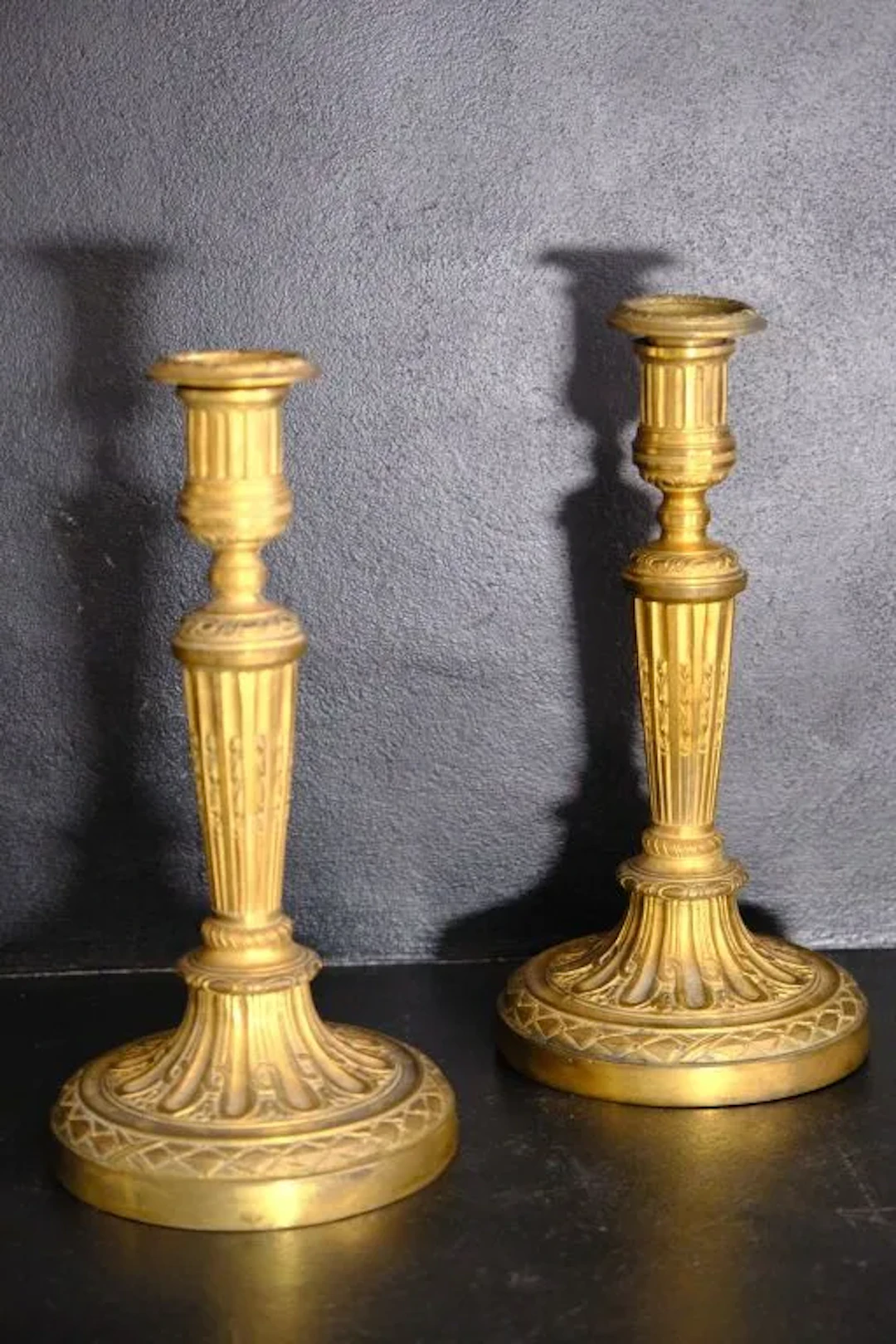 Pair of Louis XVI-style candlesticks and their candle holders in gilded