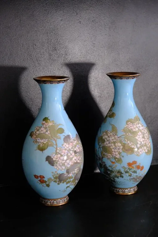 Pair of enameled vases with a light blue background and polychrome