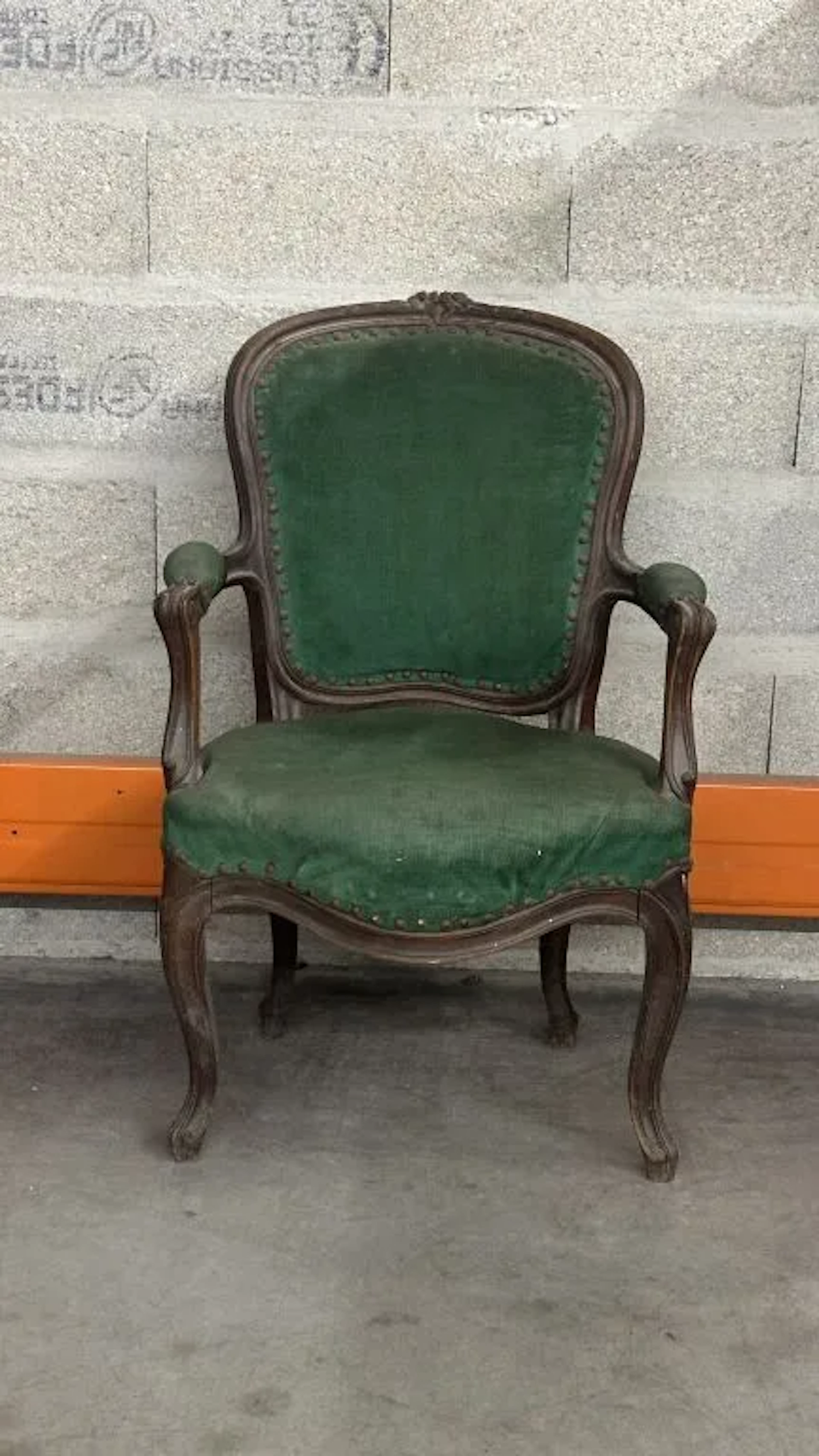 Armchair with a cabriolet backrest made of molded and carved wood;