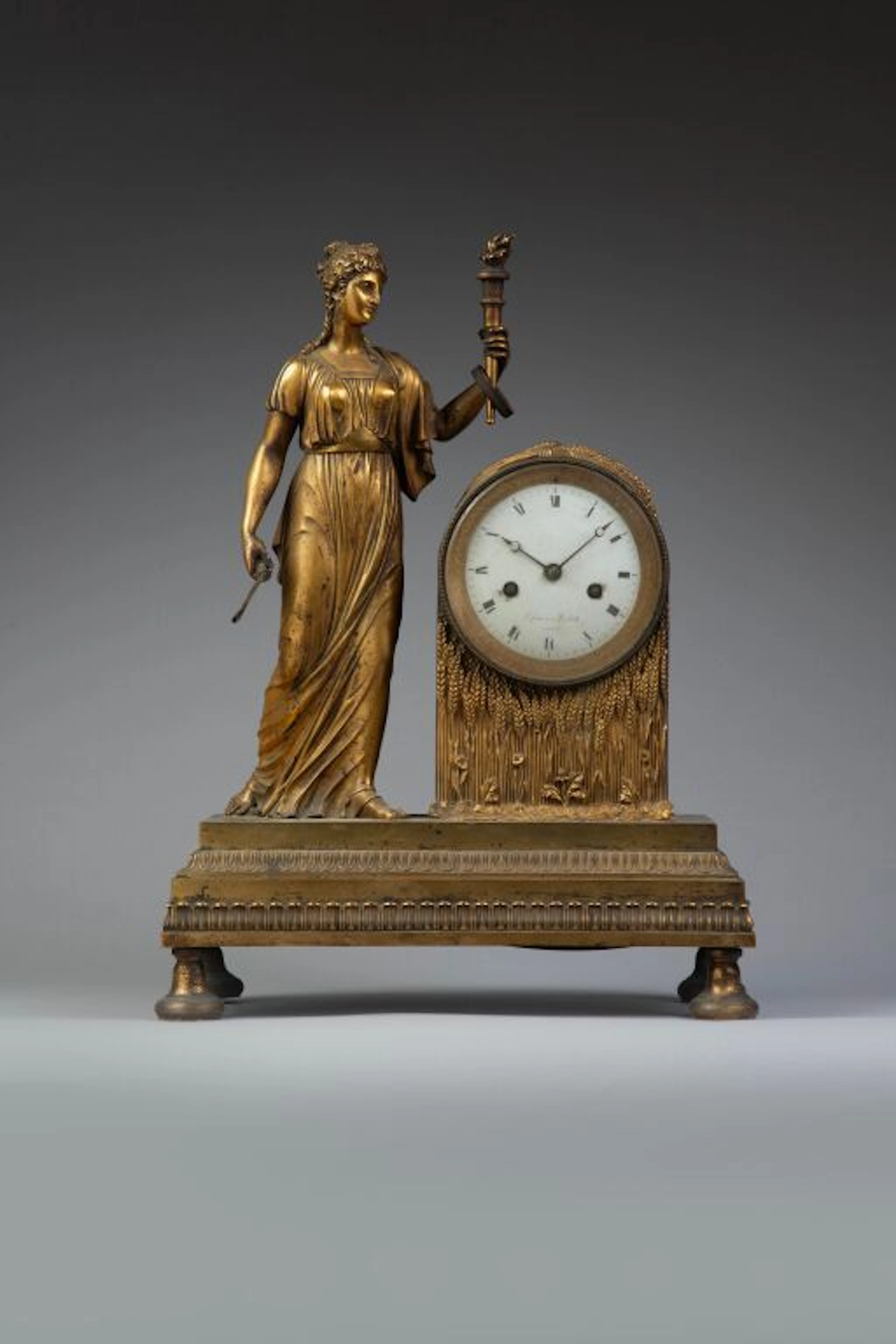A chiseled and gilded bronze clock featuring an allegory of Summer