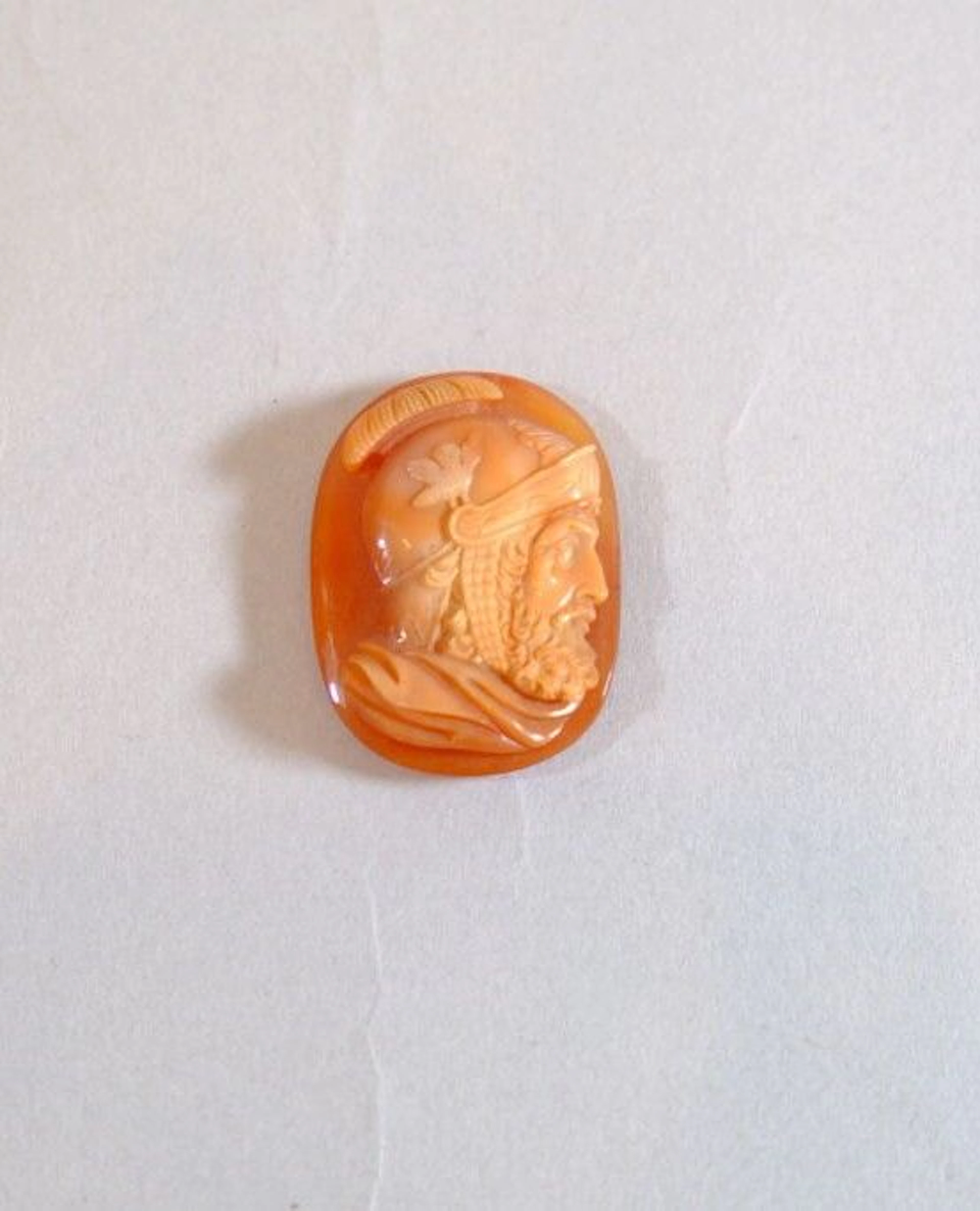 A cameo carved from multilayered carnelian depicting a man wearing