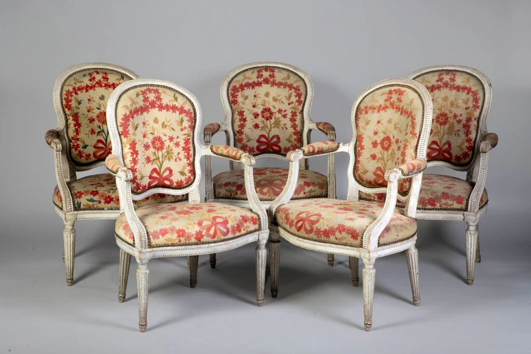 A set of five cabriolet armchairs with wavy-backed seats, made of