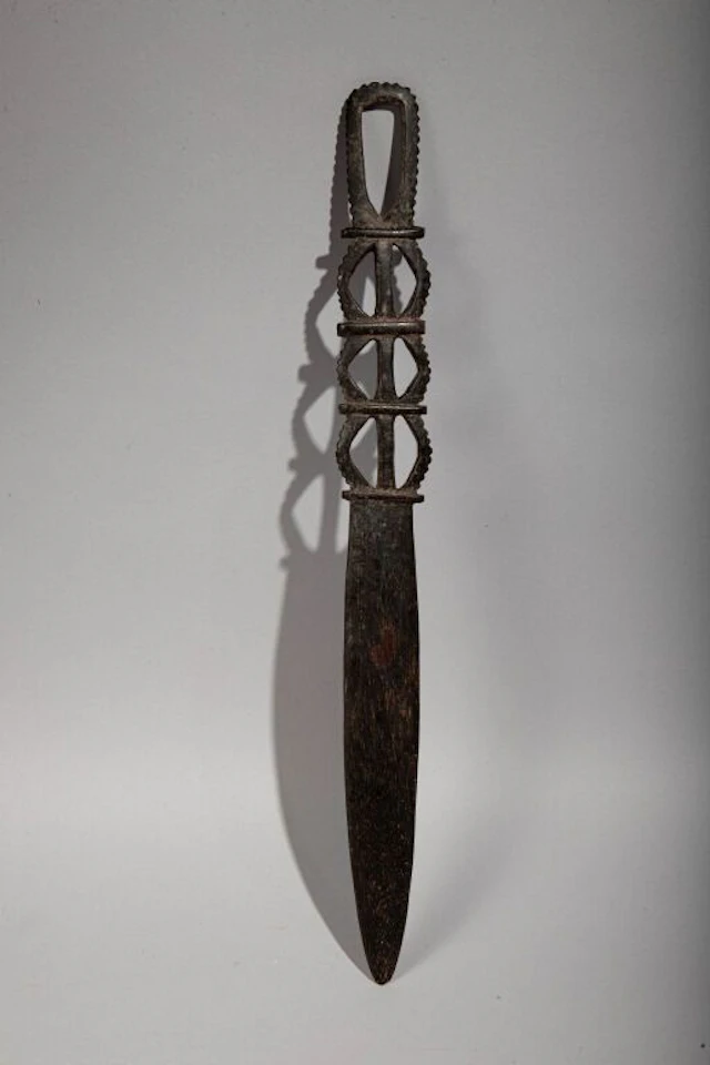Lap-lap knife with a handle featuring an openwork geometric design.