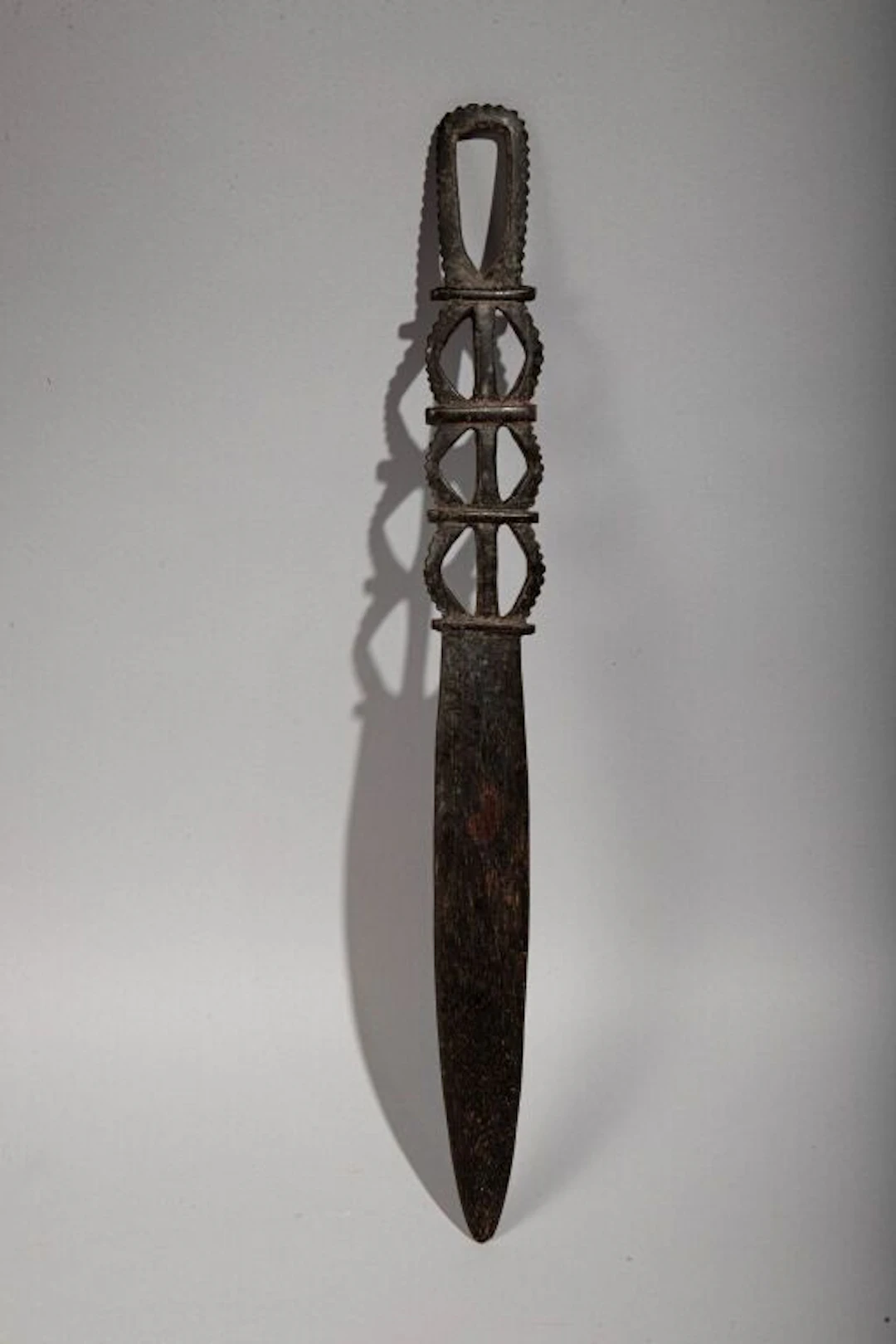 Lap-lap knife with a handle featuring an openwork geometric design.