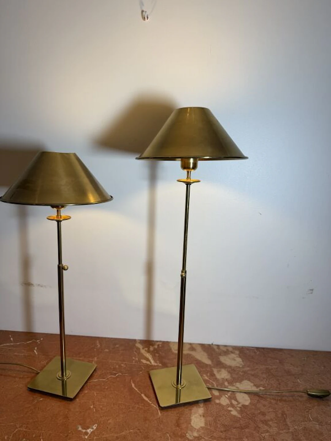 Pair of brass lamps with adjustable stems (adjusted via a screw knob)