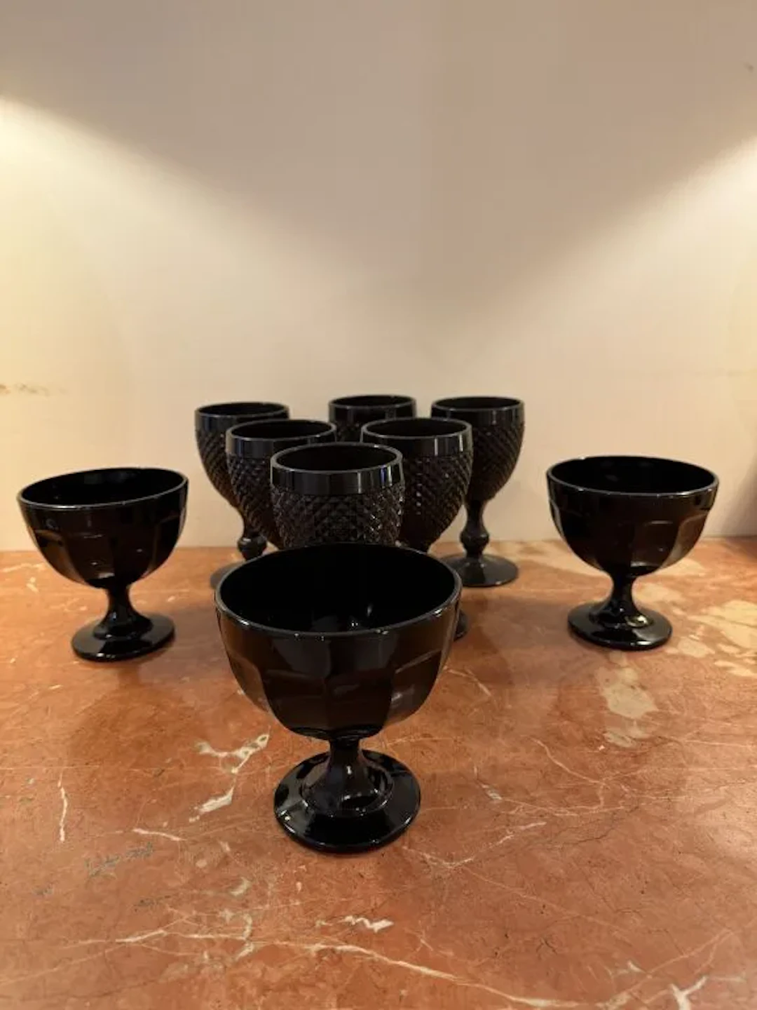 Set of six stemmed glasses and three fruit bowls on a black-tinted