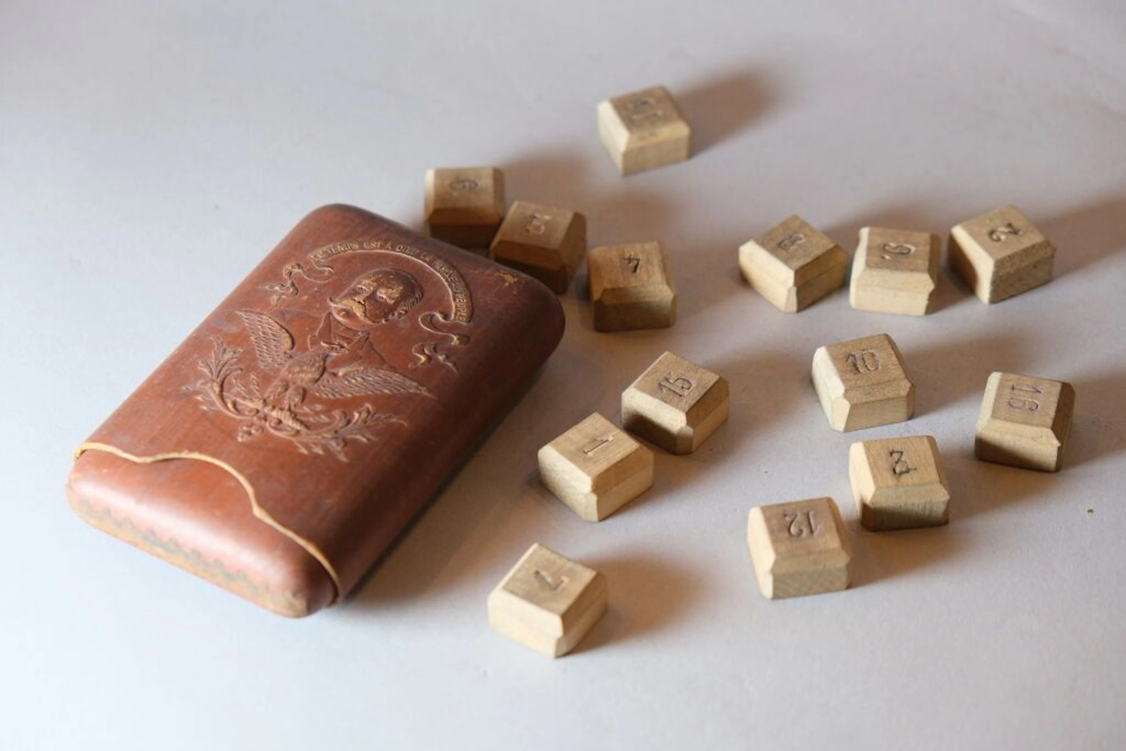 A wooden children's toy, in a wooden box bearing the image of Marshal