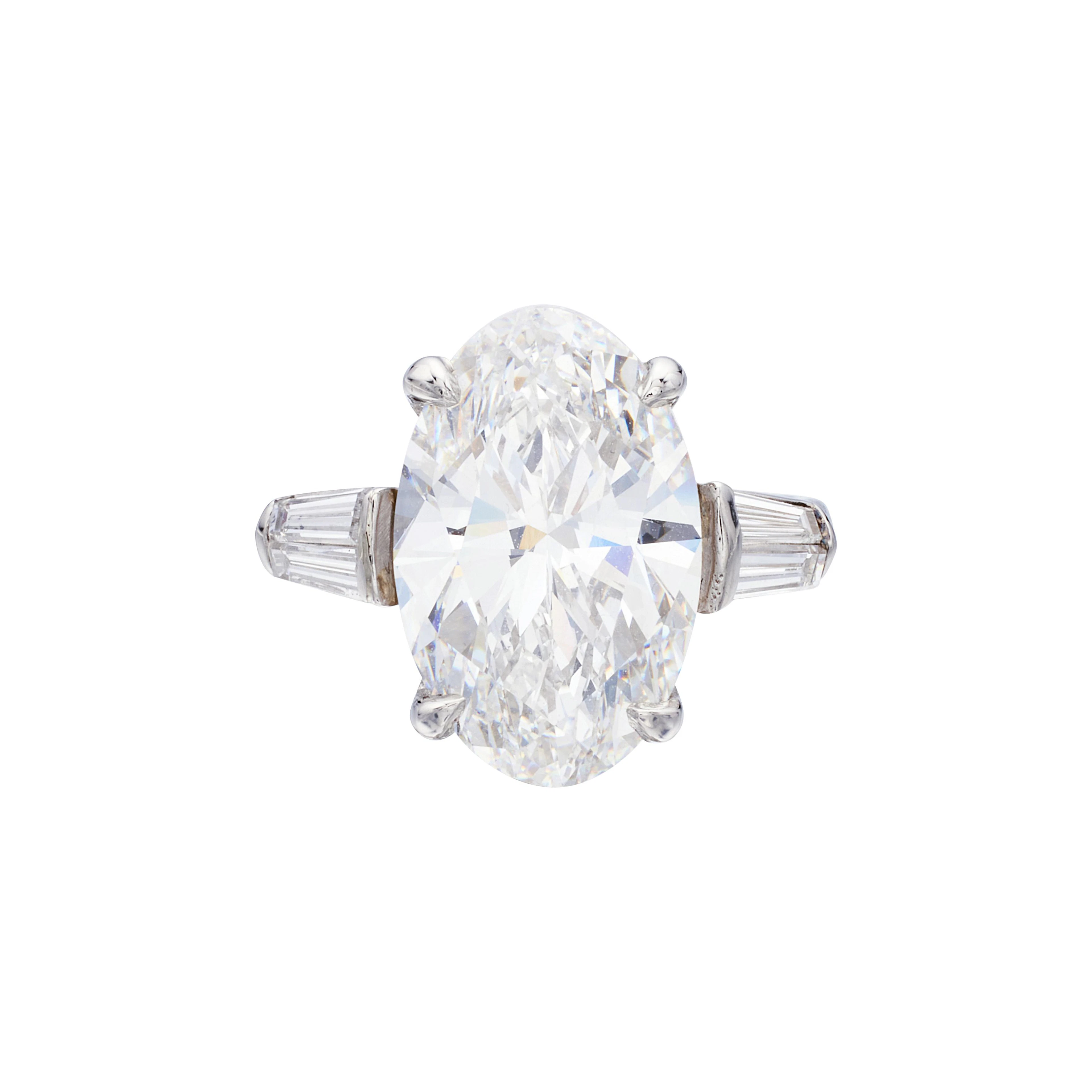 Platinum, 7.20ct Oval Cut Diamond and Diamond Engagement Ring
