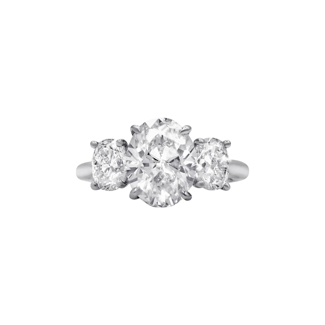 Platinum, 3.26ct Oval Cut Diamond and Diamond Three Stone Engagement Ring