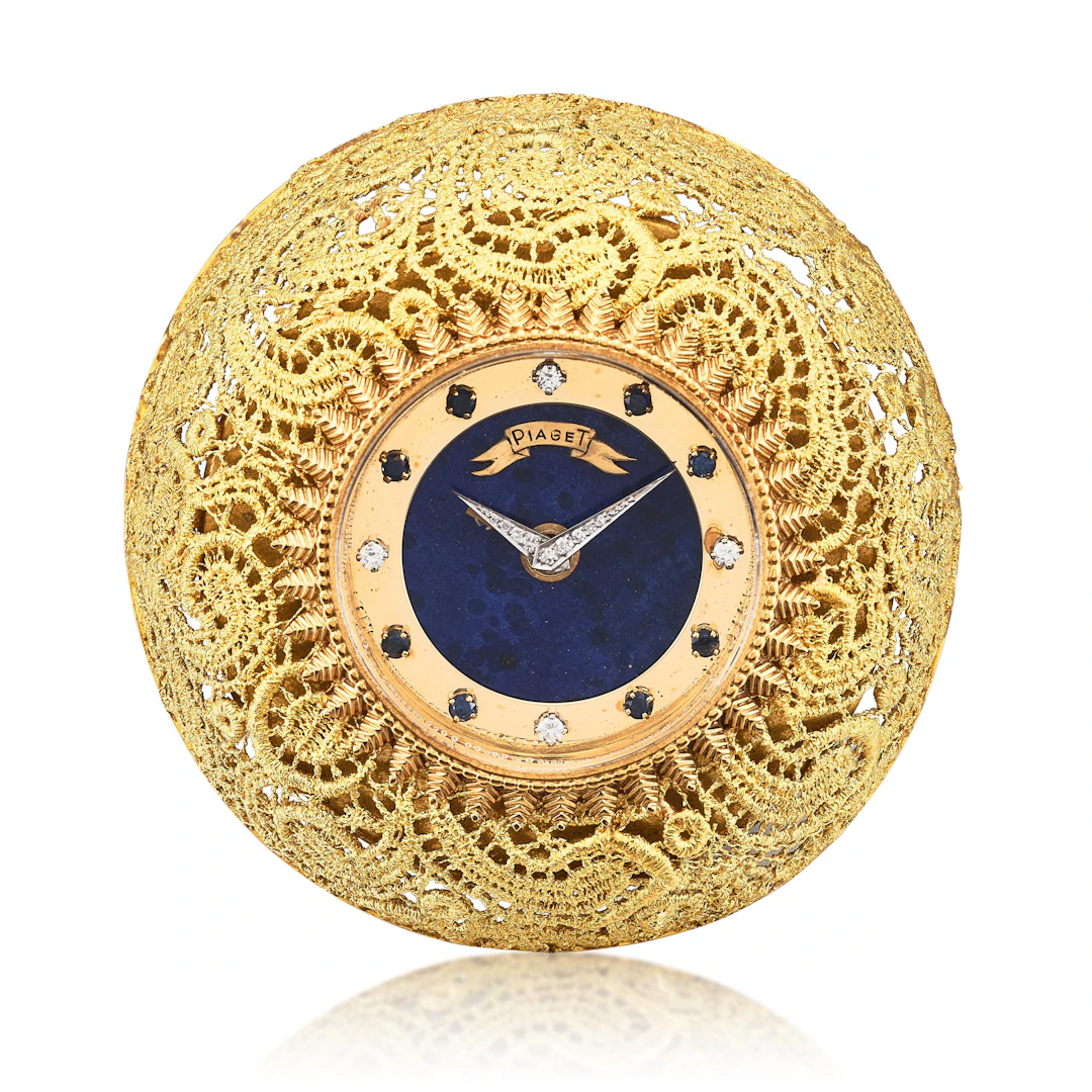 A yellow gold, diamond and sapphire-set manual wind alarm clock with