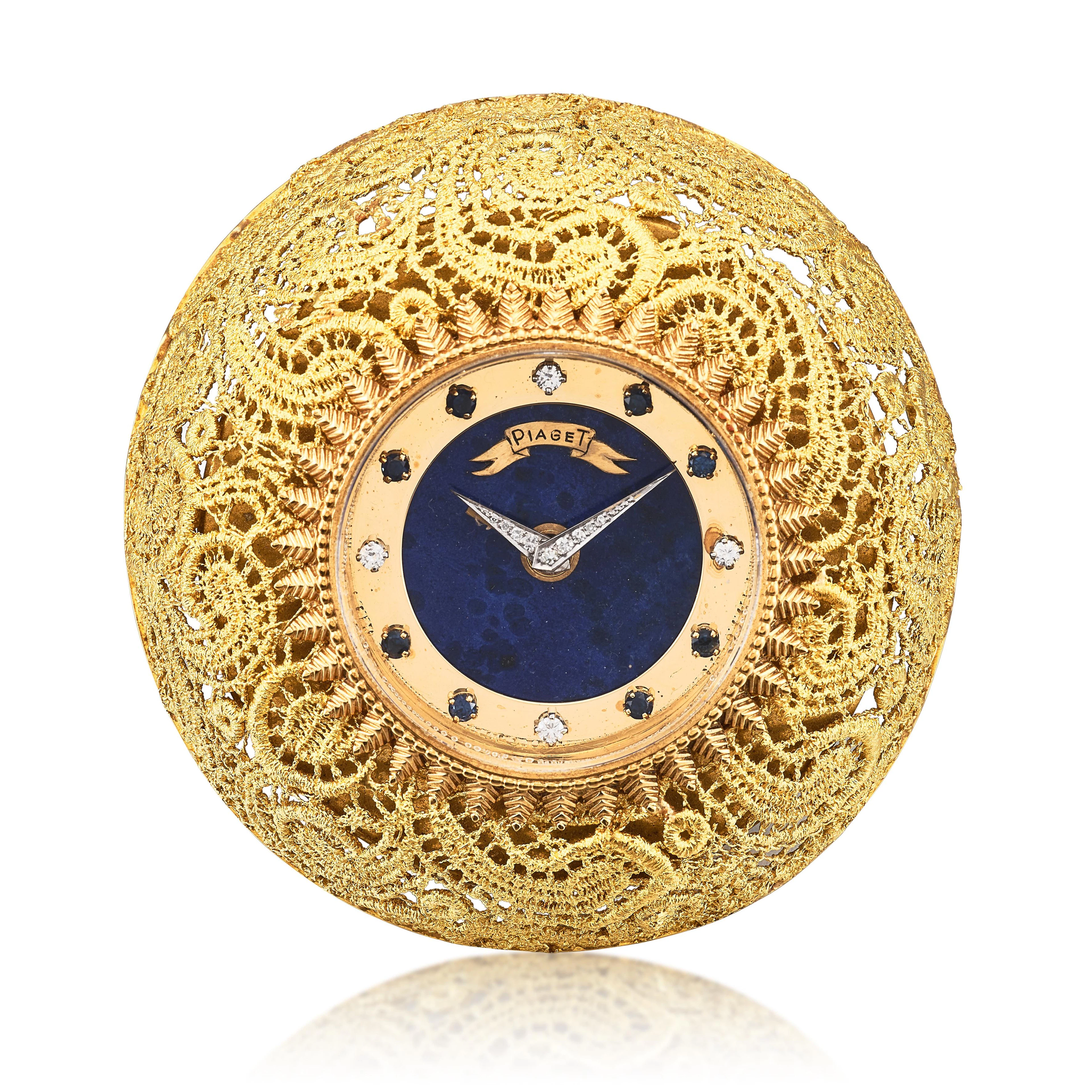 A yellow gold, diamond and sapphire-set manual wind alarm clock with
