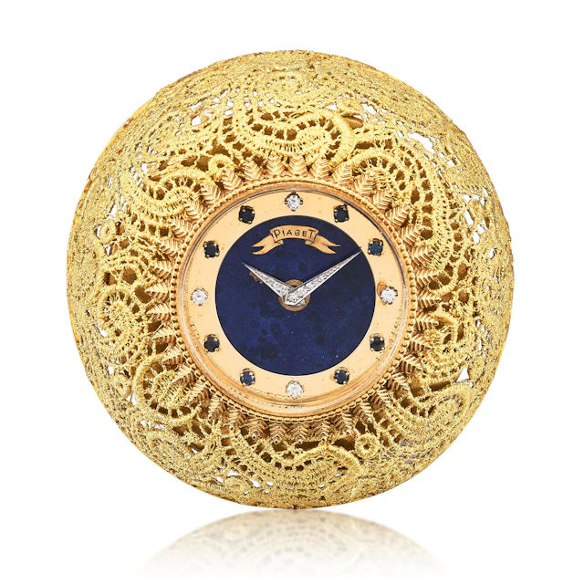 A yellow gold, diamond and sapphire-set manual wind alarm clock with
