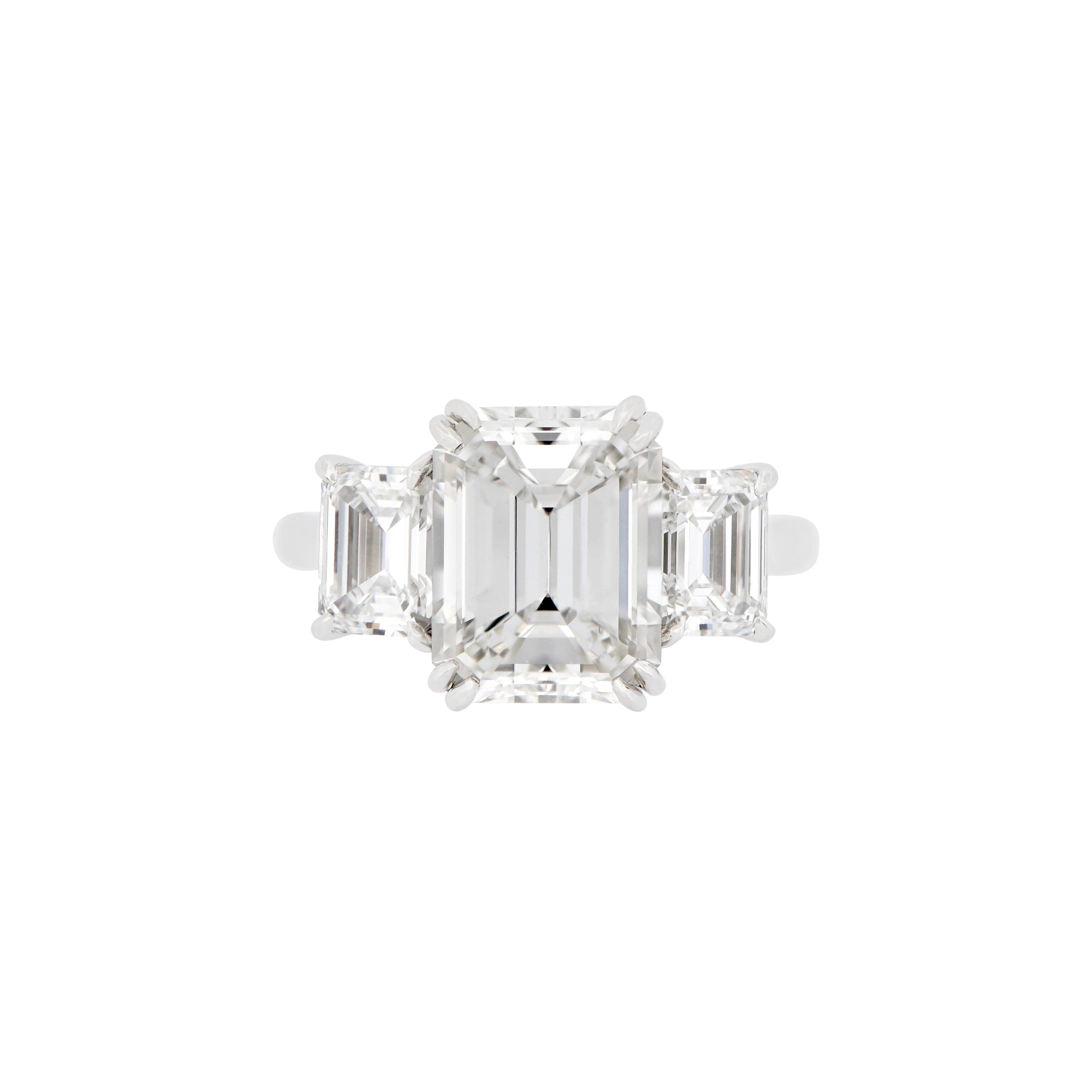 Platinum, 4.02ct Emerald Cut Diamond and Diamond Three Stone Engagement Ring