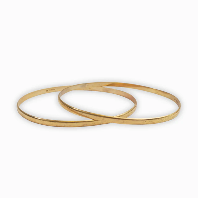 Dos pulseras esclavas en oro de 9 K.