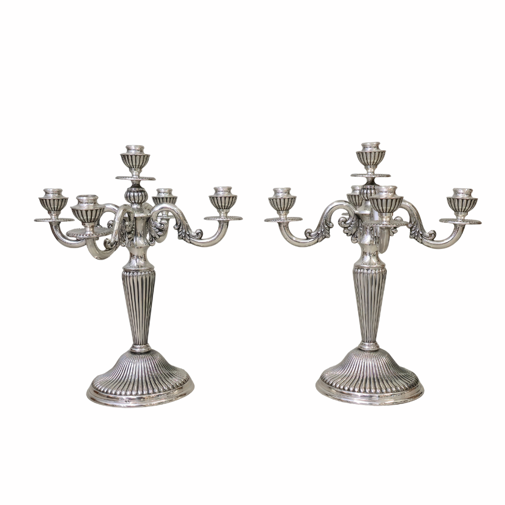 Dos candelabros de cinco luces en plata punzonada española.