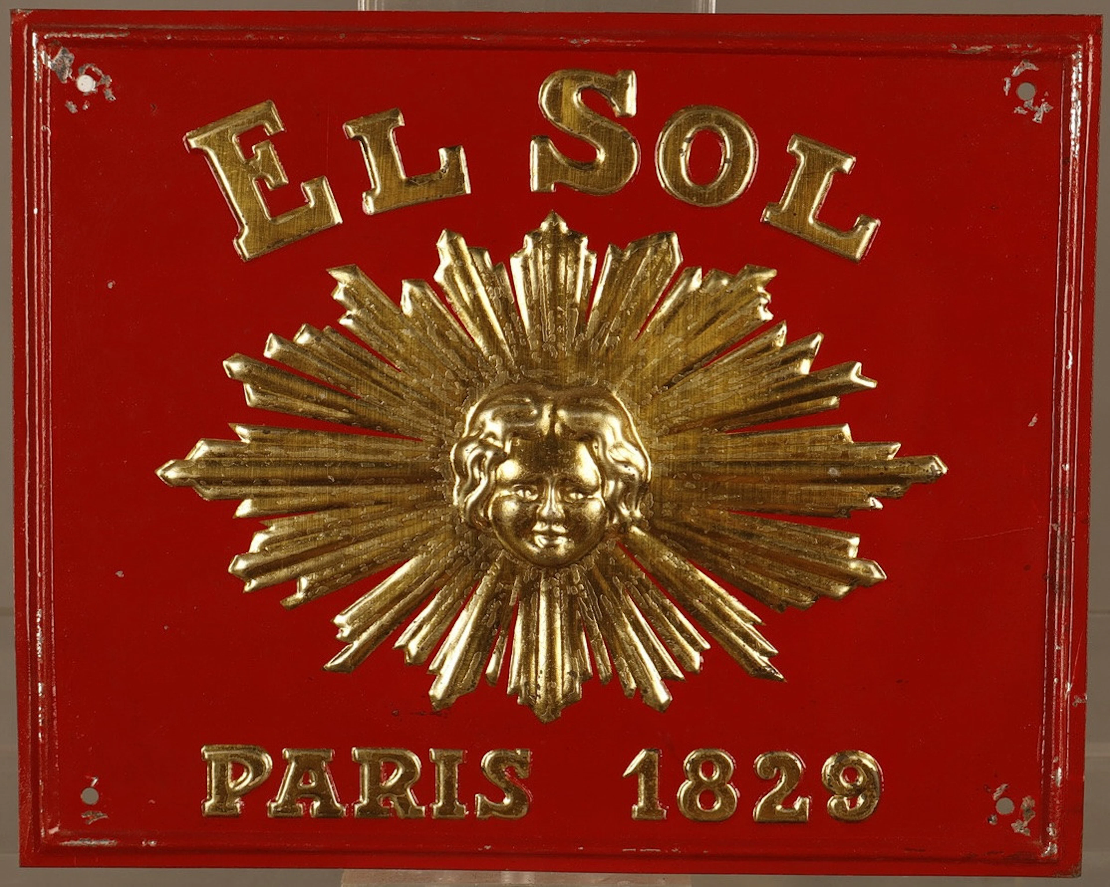 El Sol, placa publicitaria en hojalata estampada y pintada.