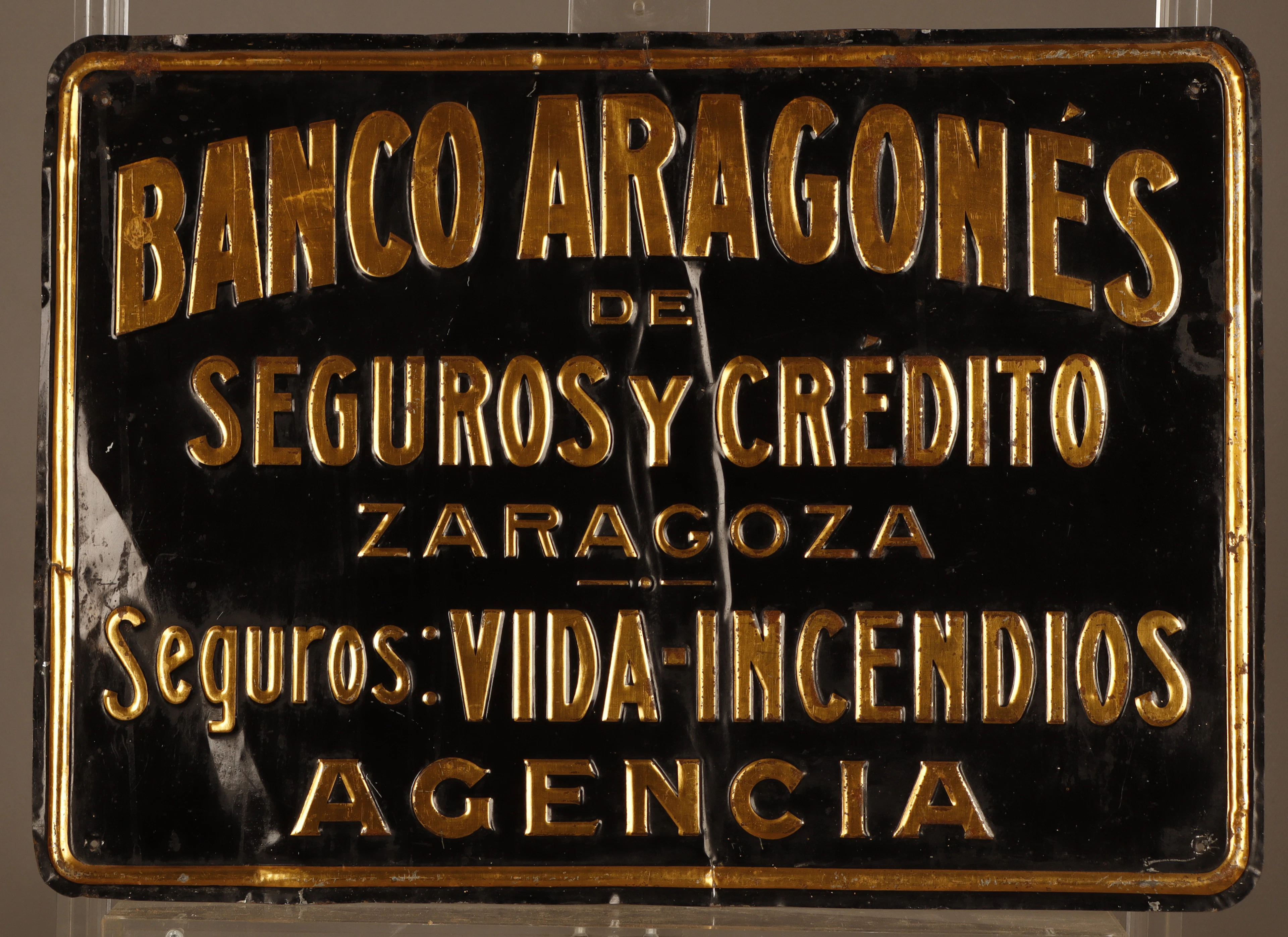 Banco Aragonés de Seguros y Crédito, placa publicitaria en hojalata