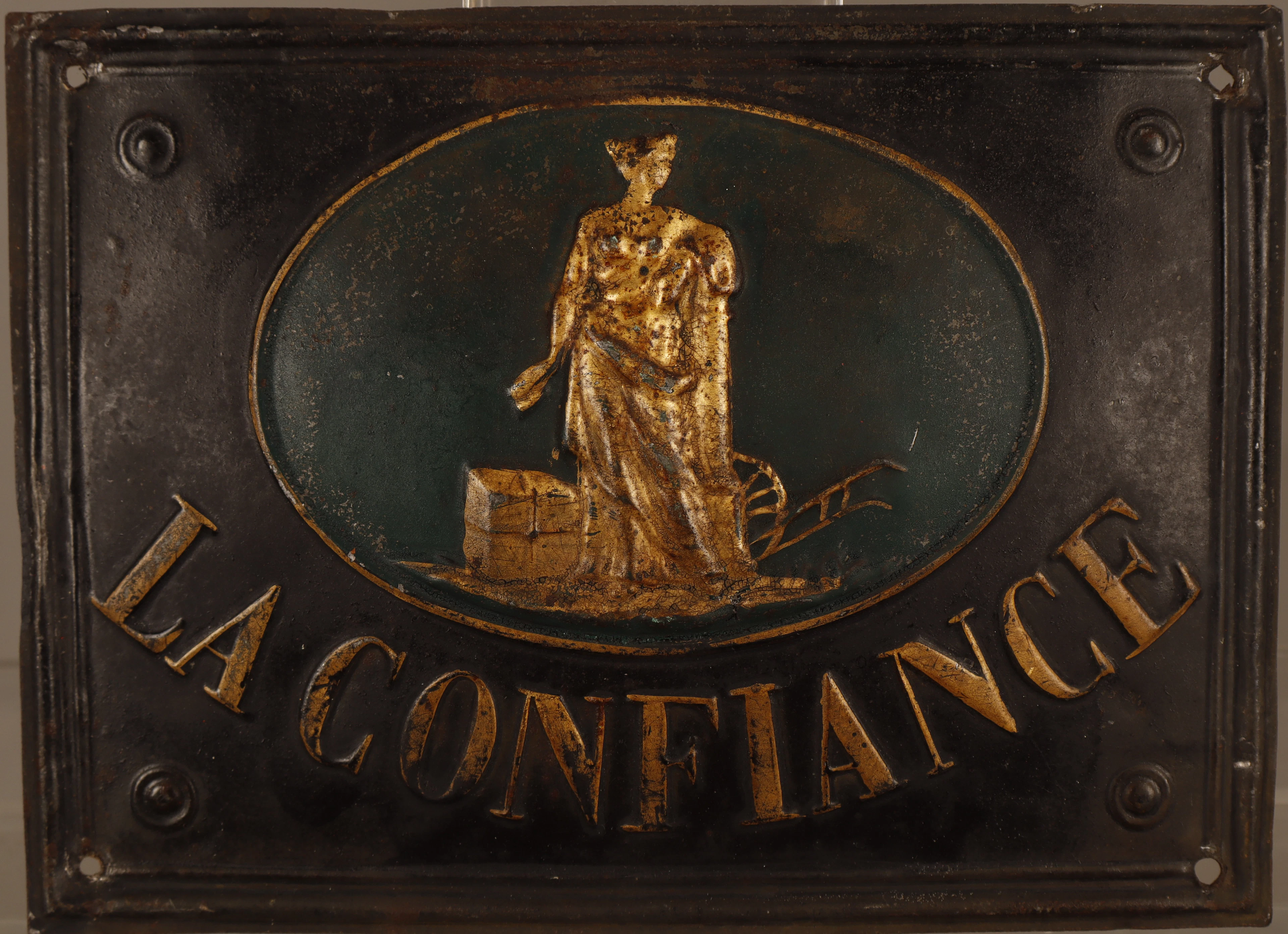 La Confiance, placa publicitaria en hojalata estampada y pintada.