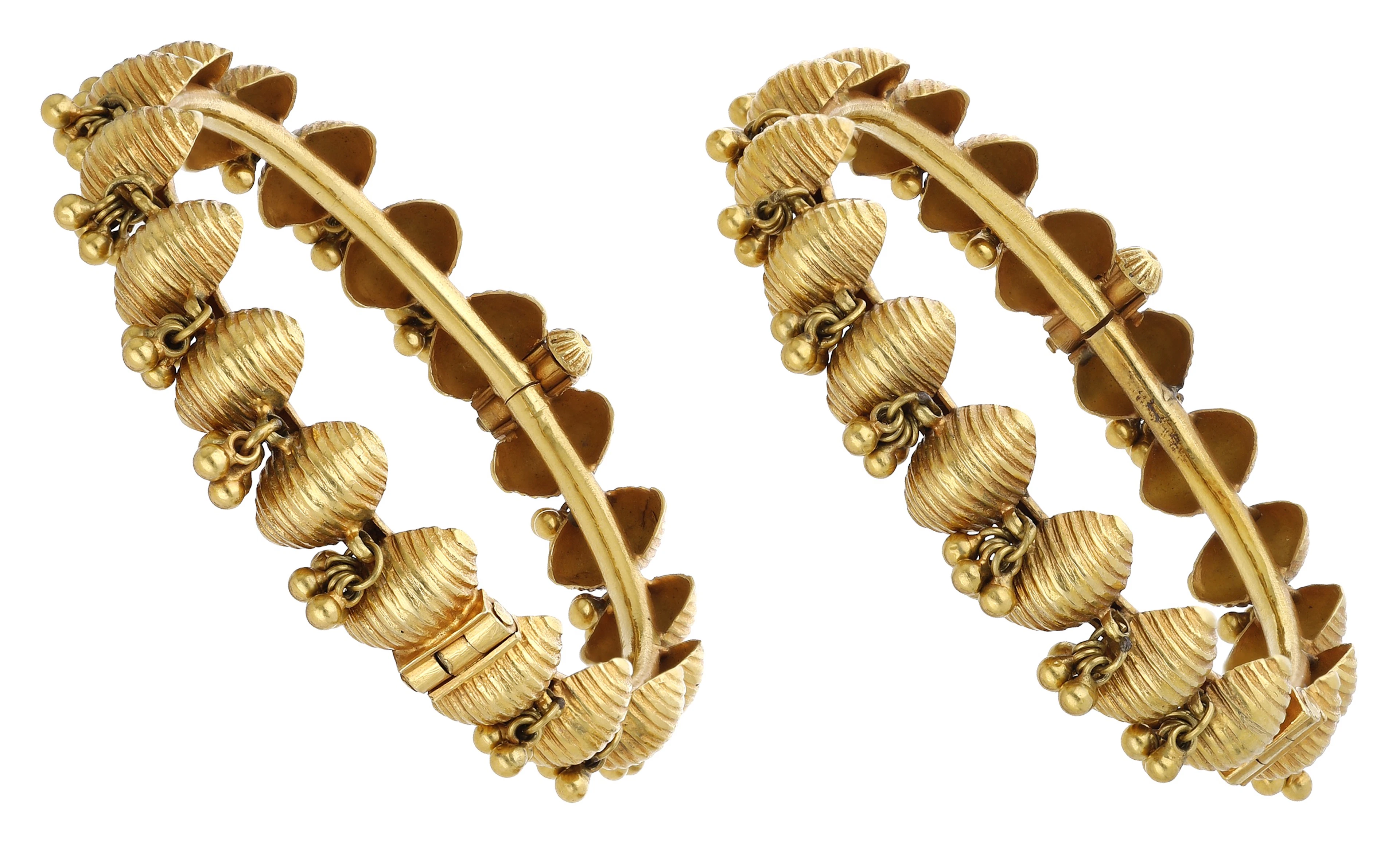 A pair of gold hinged bangles, each composed of convex reeded oval