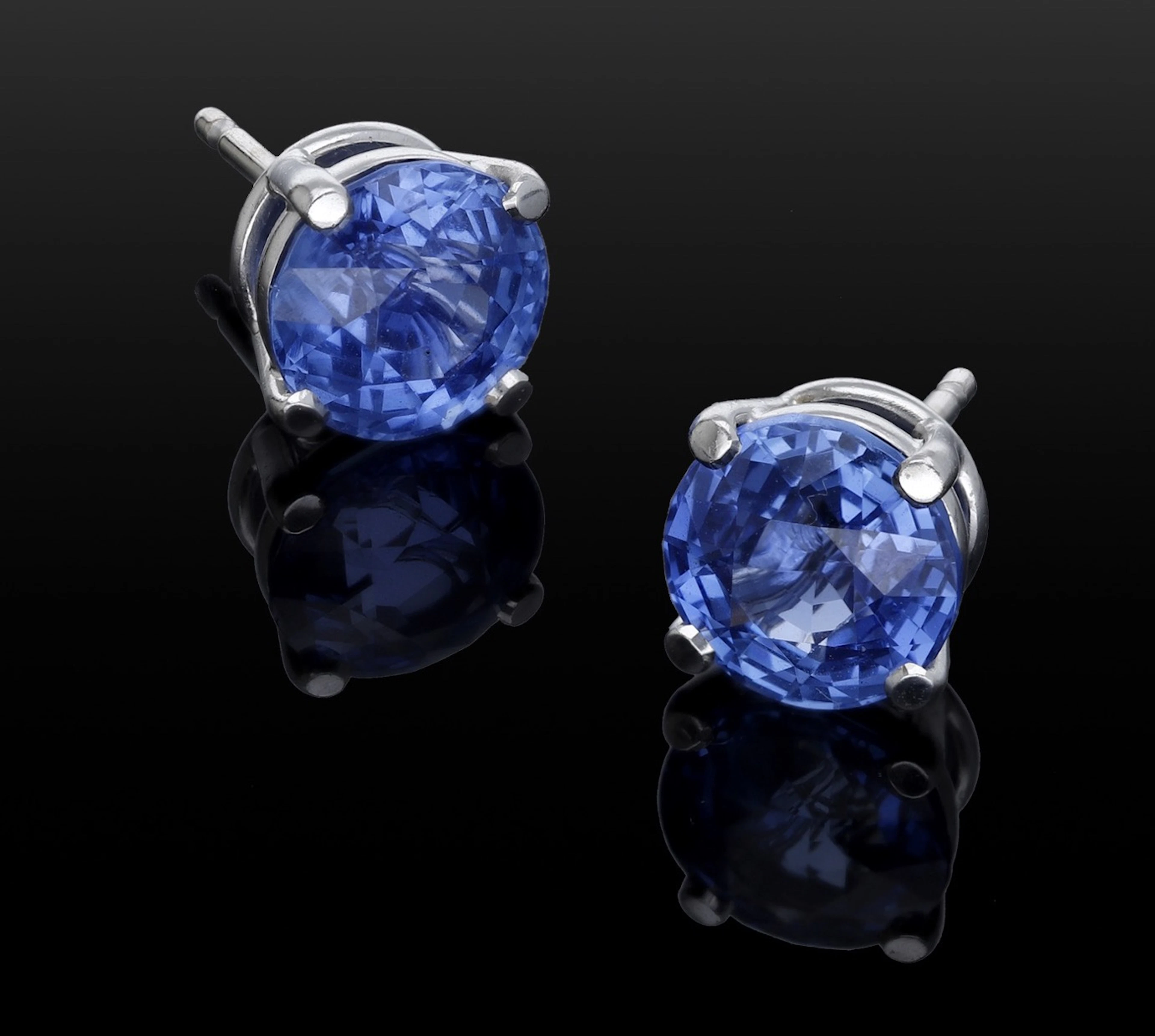 A pair of sapphire ear studs retailed by Theo Fennell, the circular