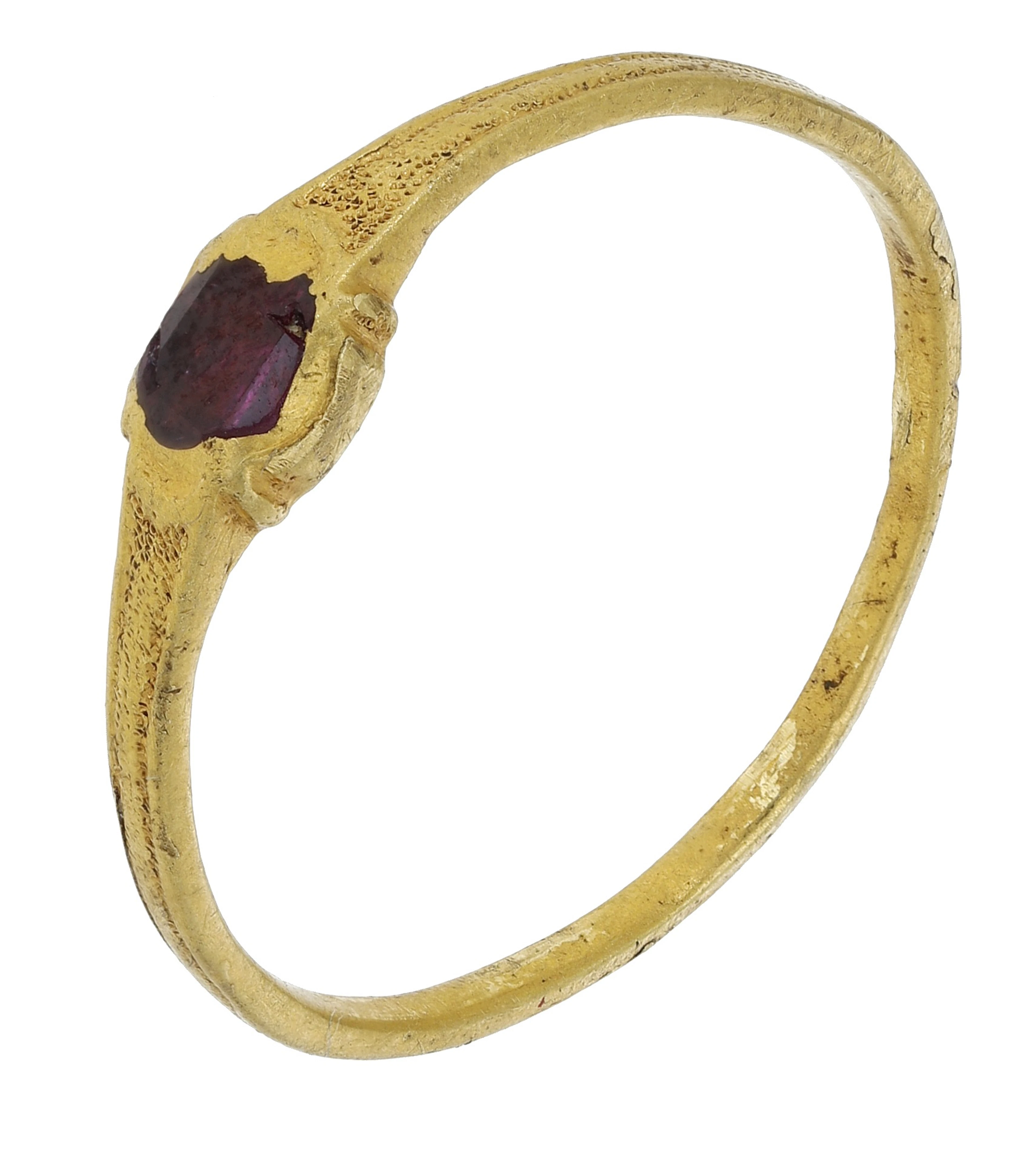 A Medieval garnet ring, circa AD. 1200-1400, the narrow gold band