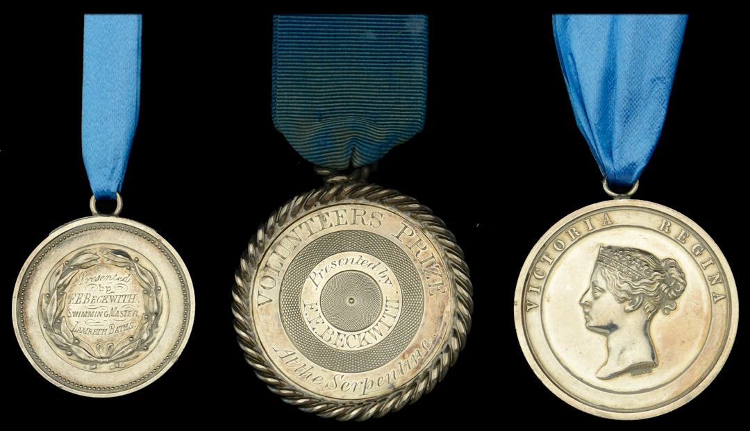 The group of three swimming medals awarded to Mr. J. Carbonell i)