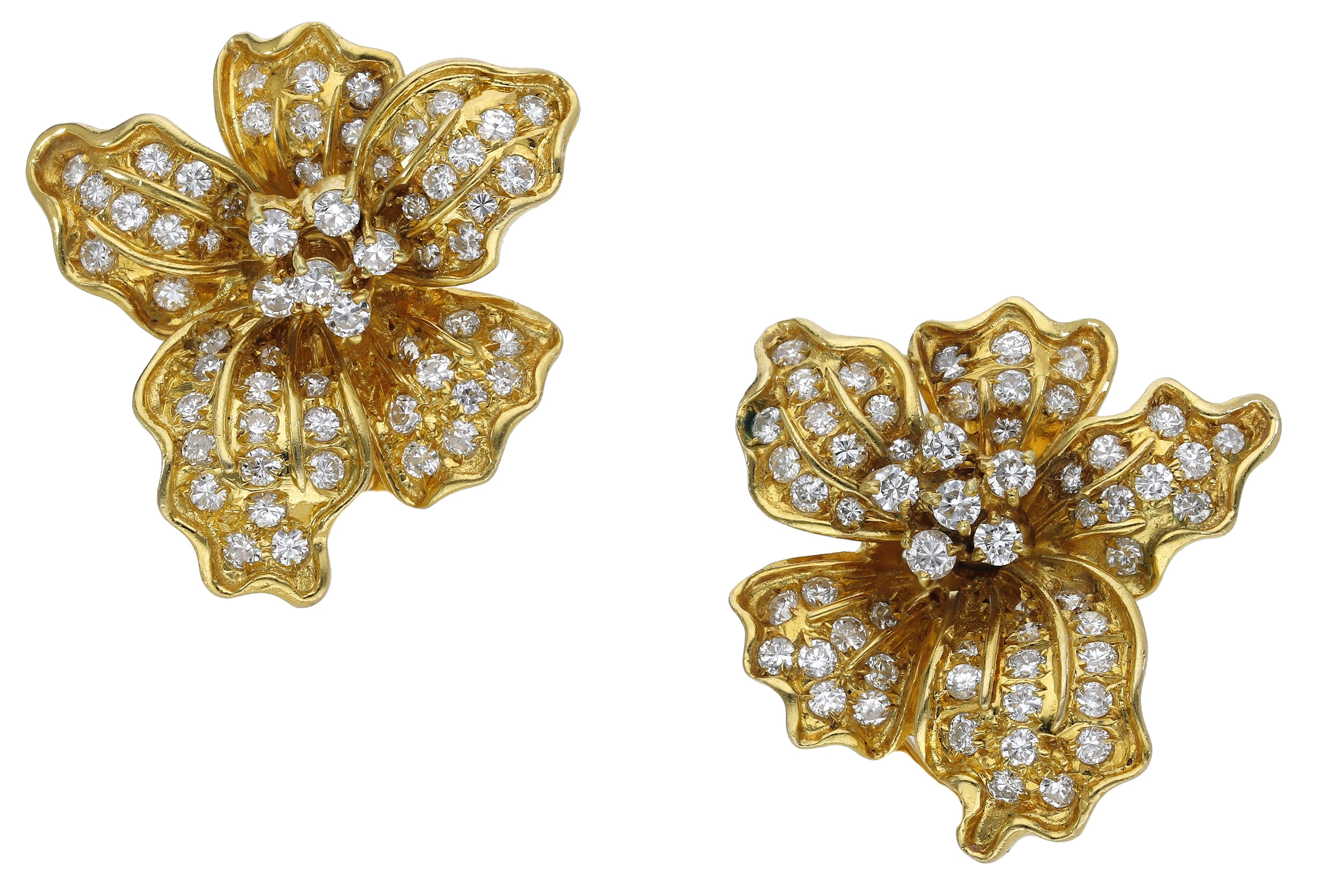 A pair of diamond en tremblant flowerhead ear clips, naturalistically