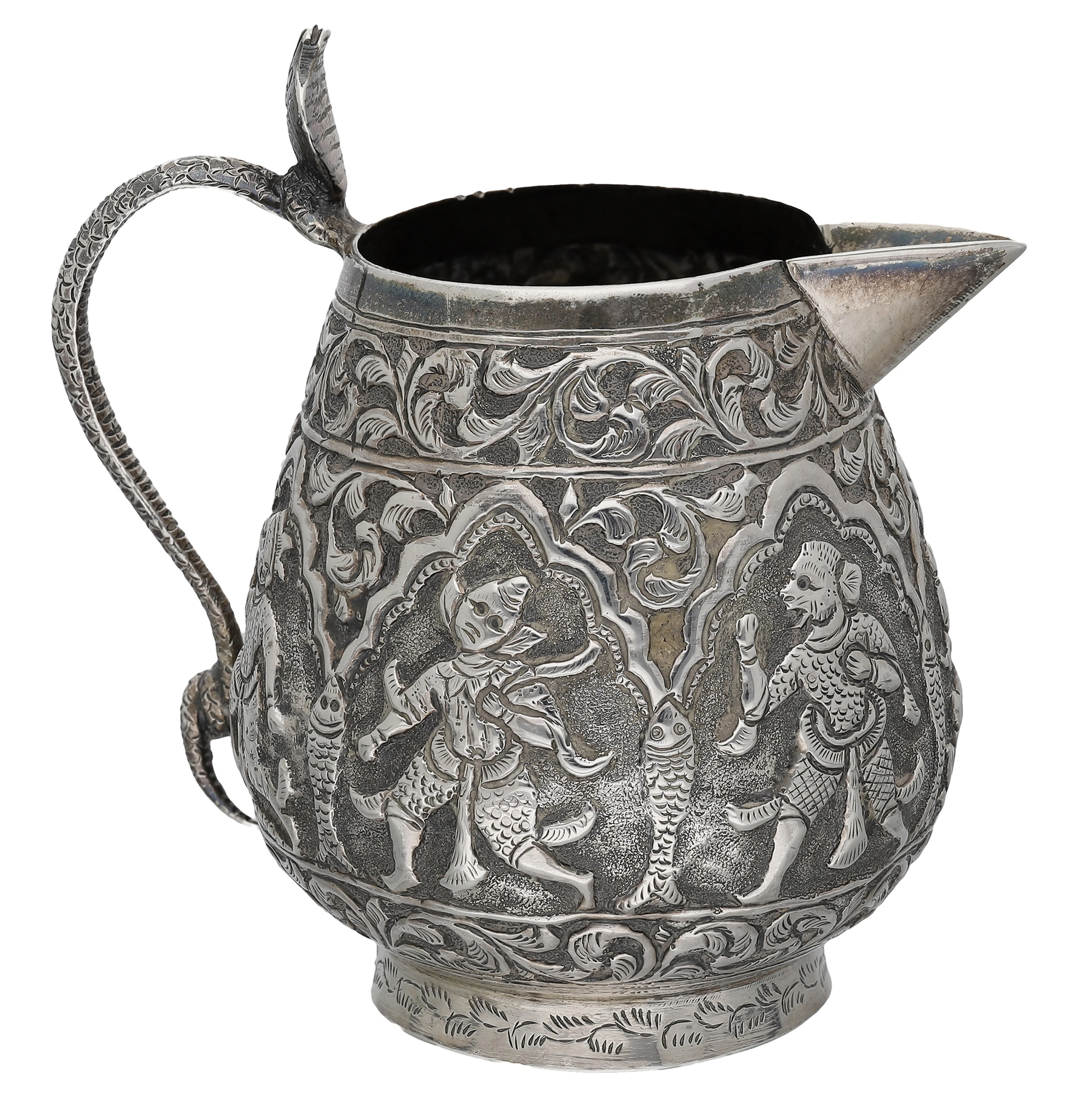 An Asian silver cream jug, probably Burmese, repoussé decorated with